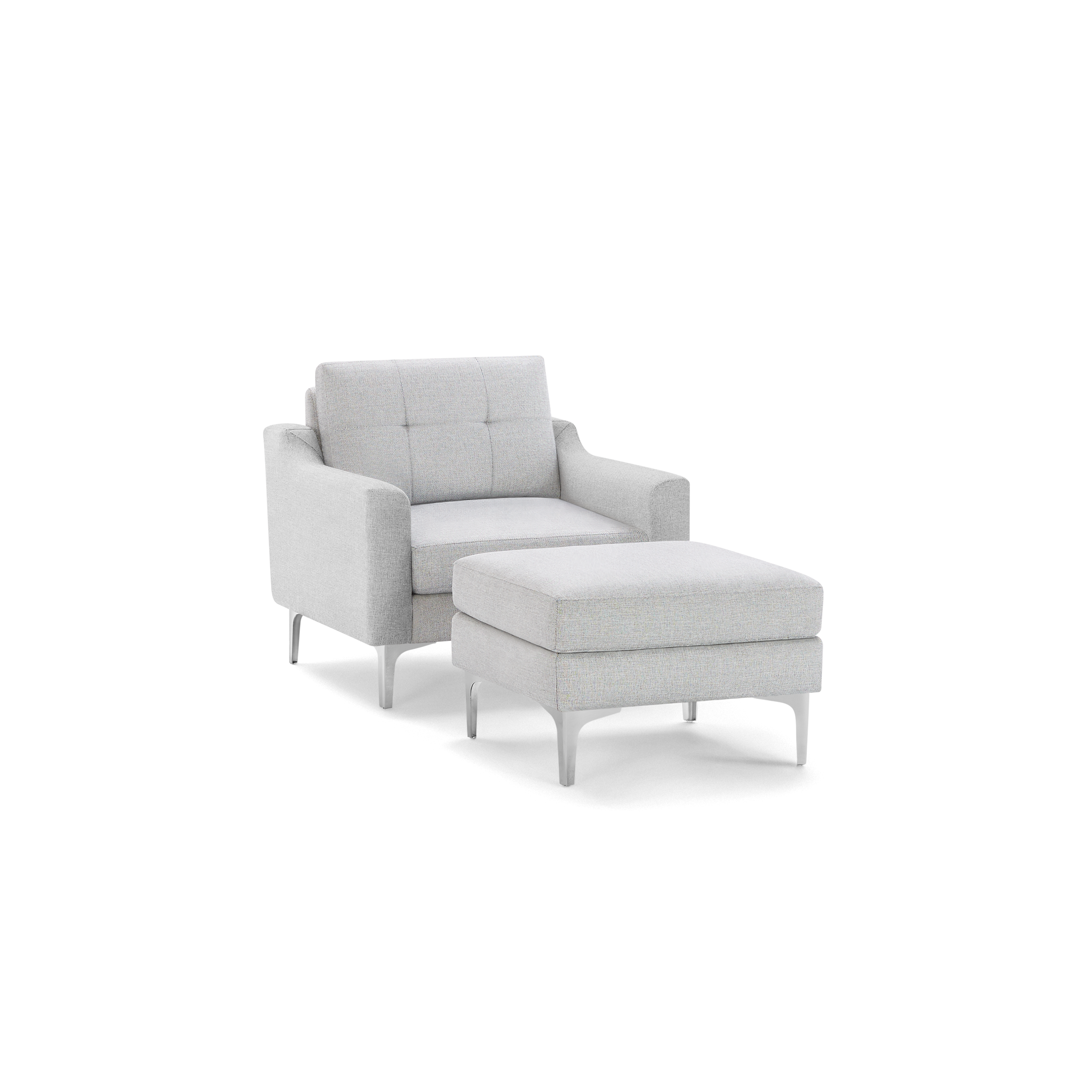 Light gray upholstered armchair with tufted backrest and matching cushioned ottoman, both featuring sleek silver legs.