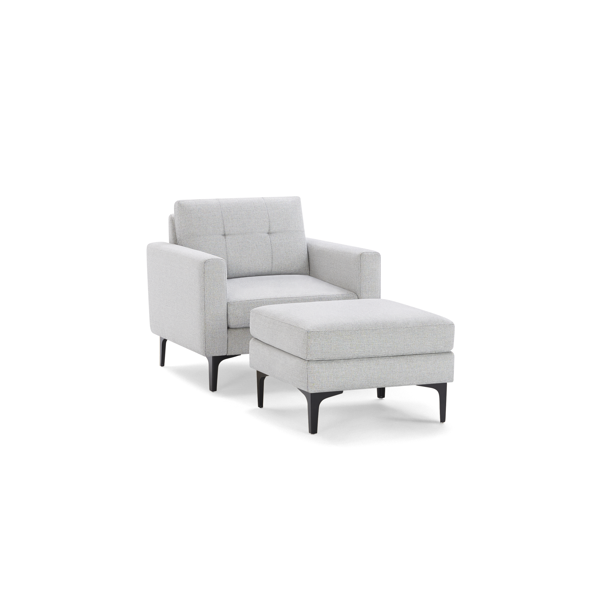 Light gray upholstered armchair with matching ottoman, square arms, tufted backrest, and slender black legs.