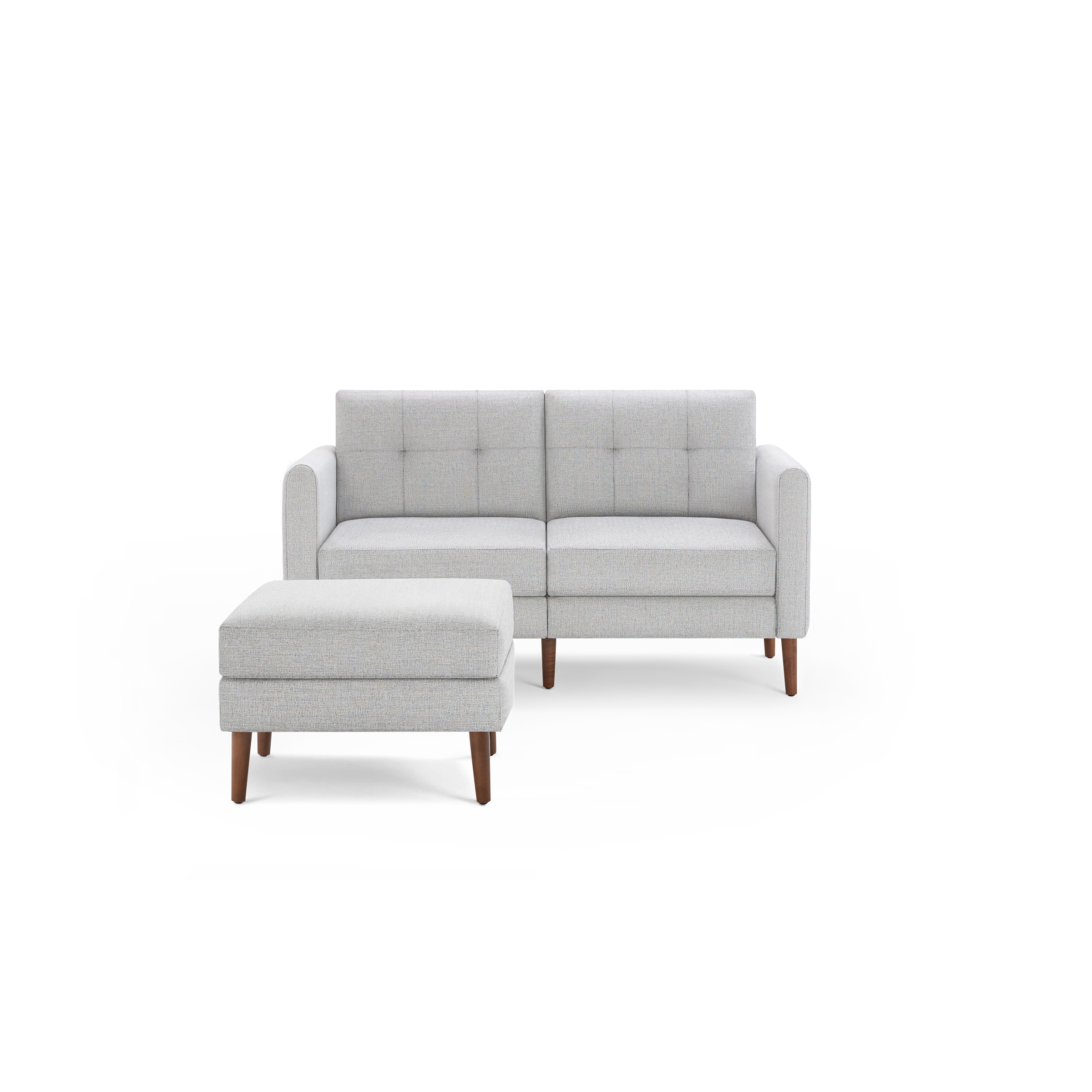 Light gray modern two-seater sofa with square tufted back cushions and a matching ottoman with wooden legs.