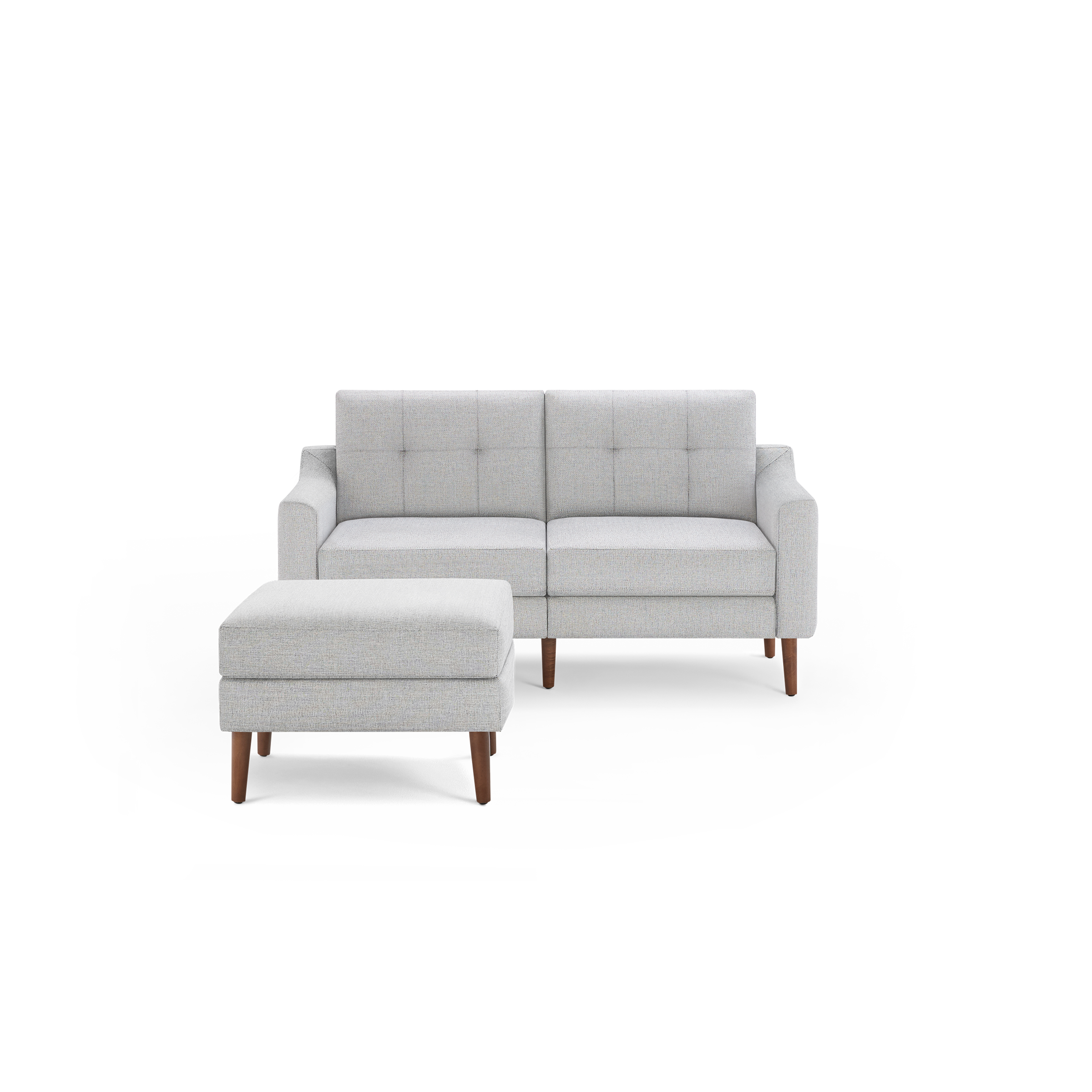 Light gray mid-century modern loveseat with tufted backrest and matching ottoman on wooden legs, isolated on black background.