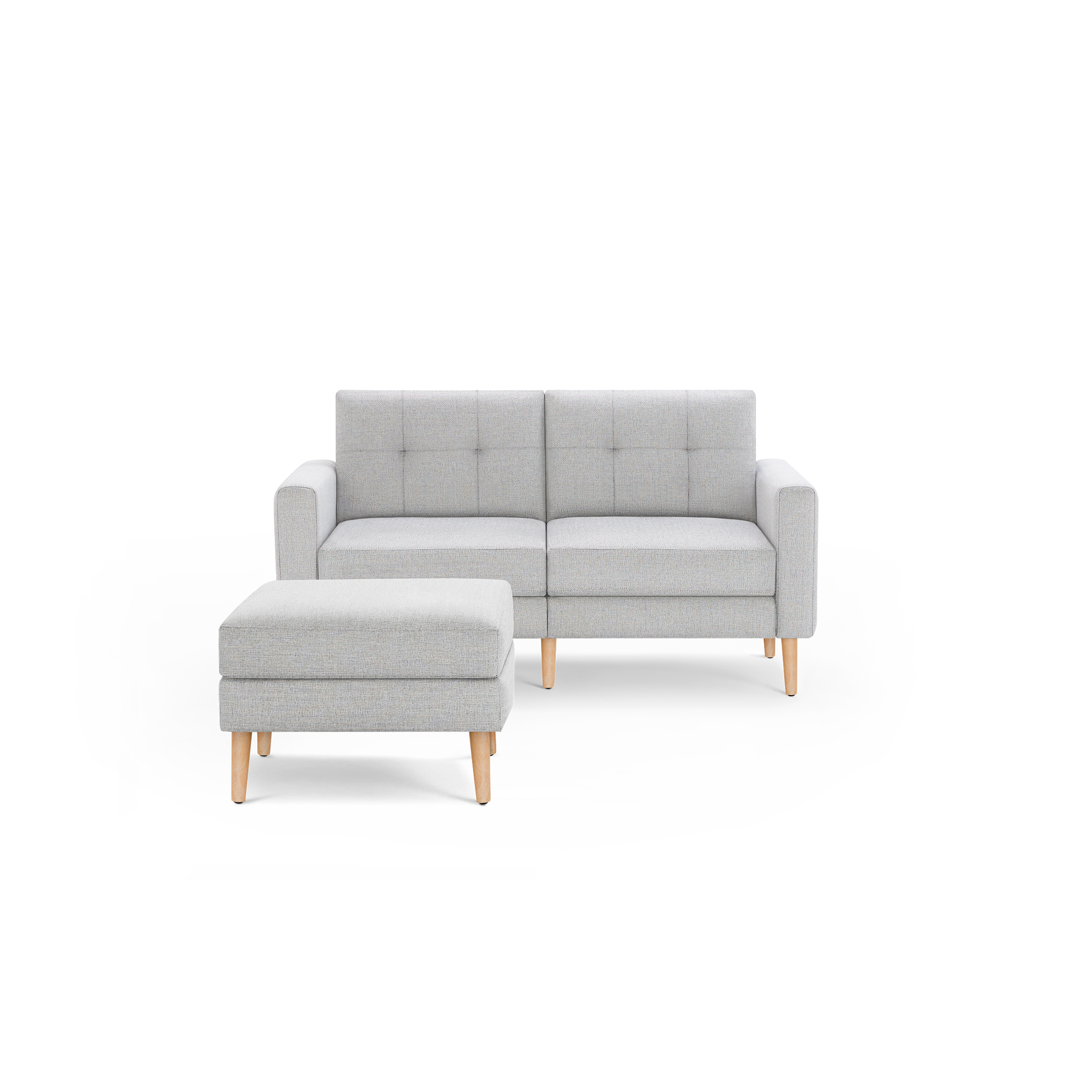 Light gray two-seater sofa with square tufted backrests and matching ottoman, both featuring natural wooden legs.