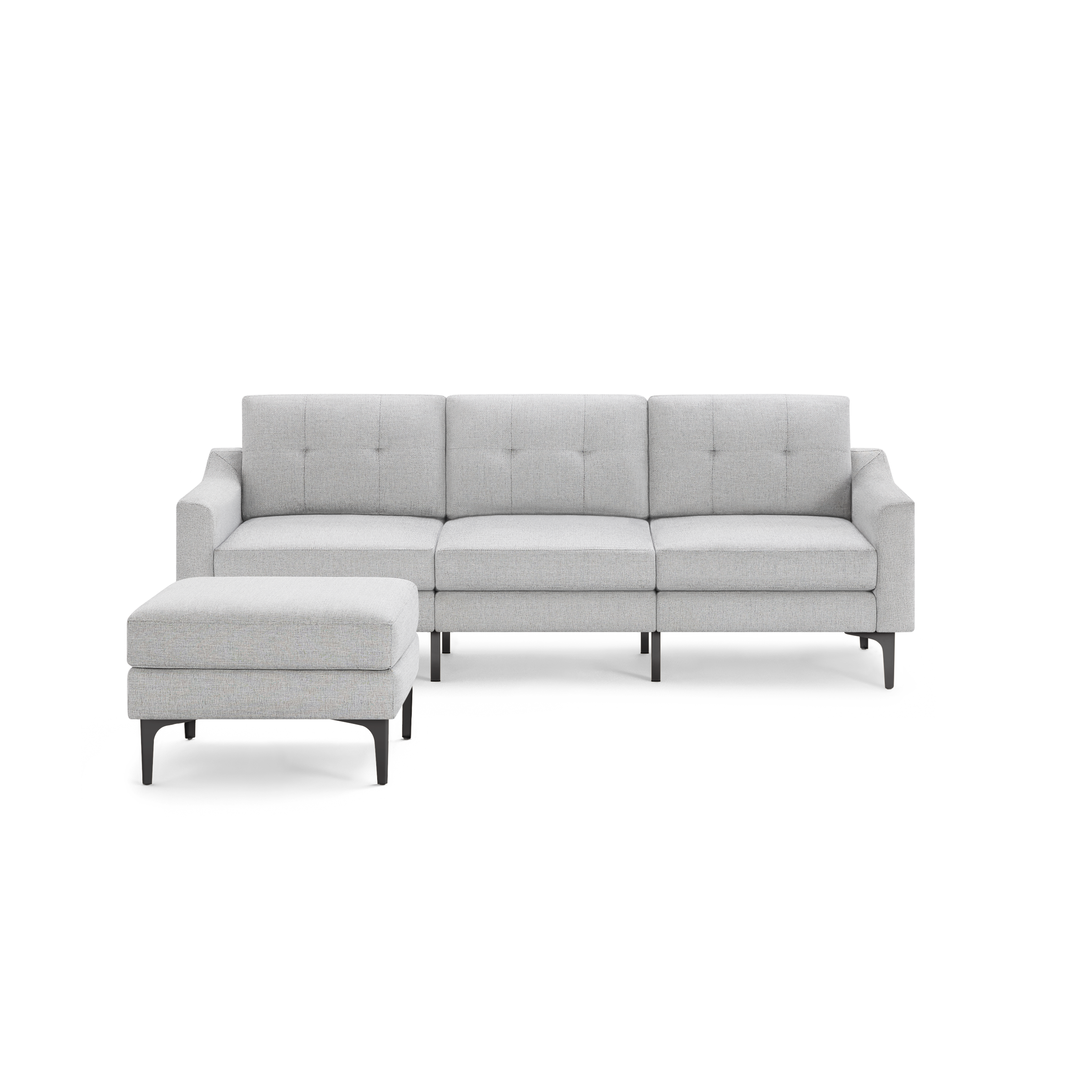 Light gray fabric sectional sofa with tufted back cushions and matching ottoman on black metal legs.