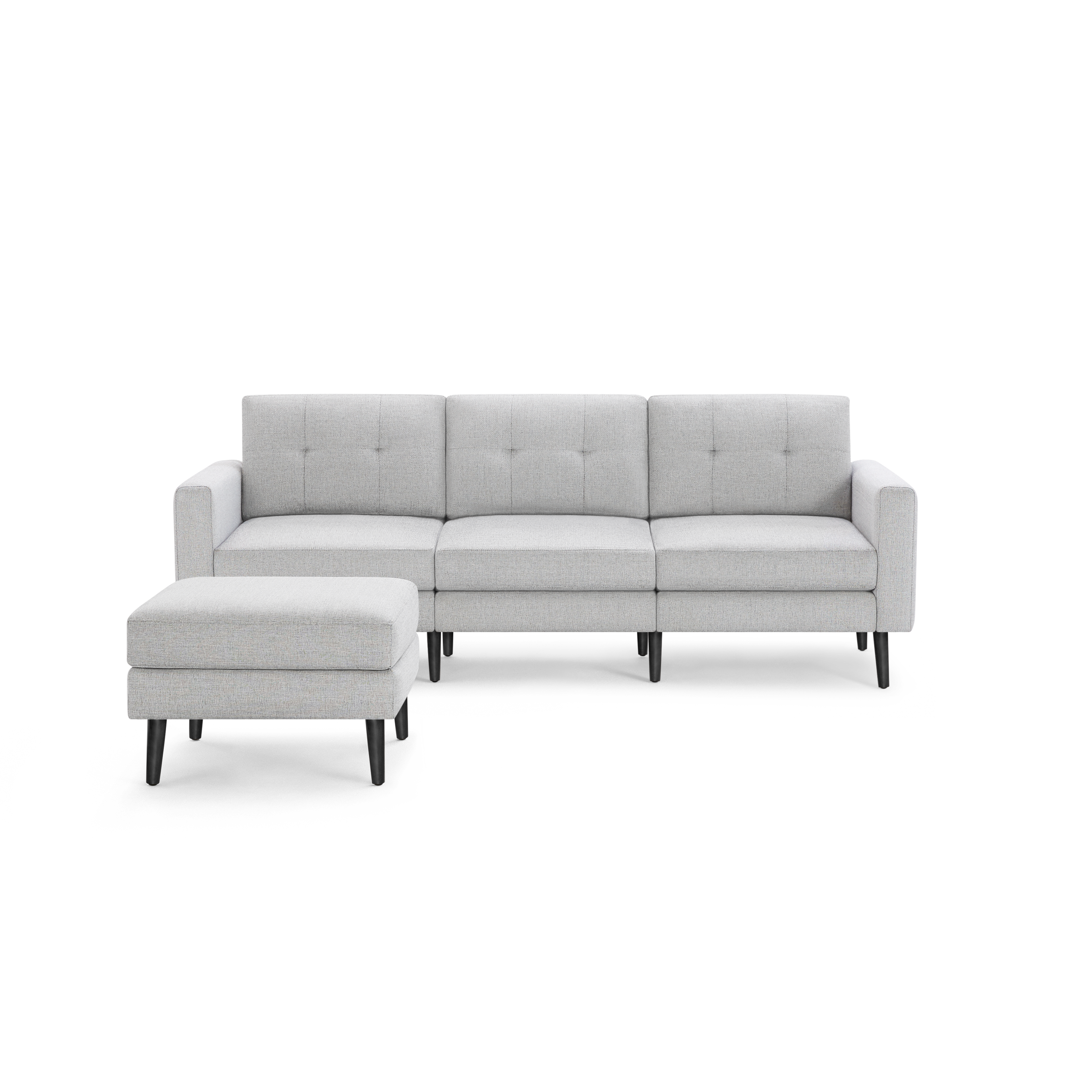 Light gray three-seater sofa with tufted back cushions and matching ottoman, featuring black tapered wooden legs.