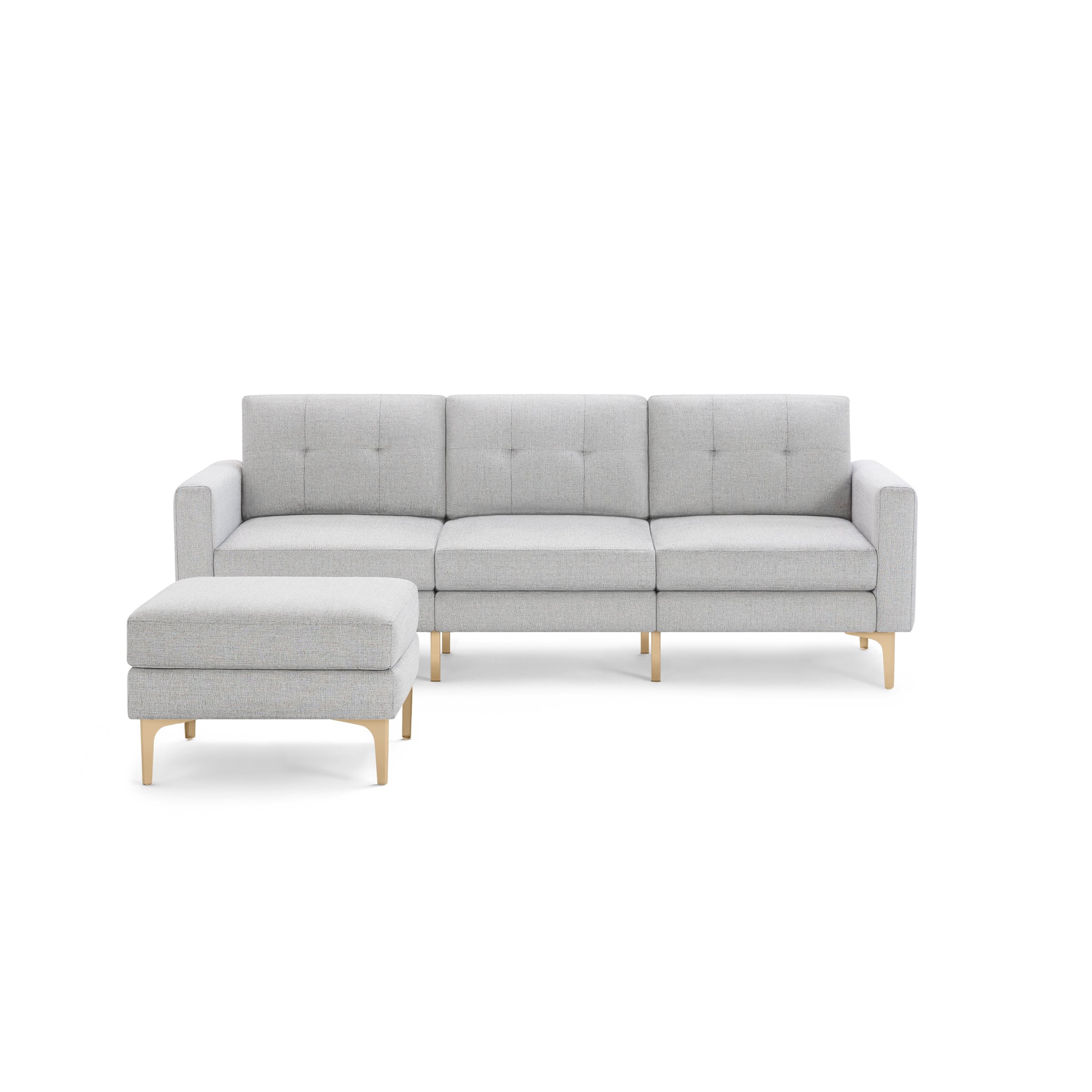 Light gray fabric sectional sofa with tufted cushions and light wood angled legs, paired with matching ottoman.
