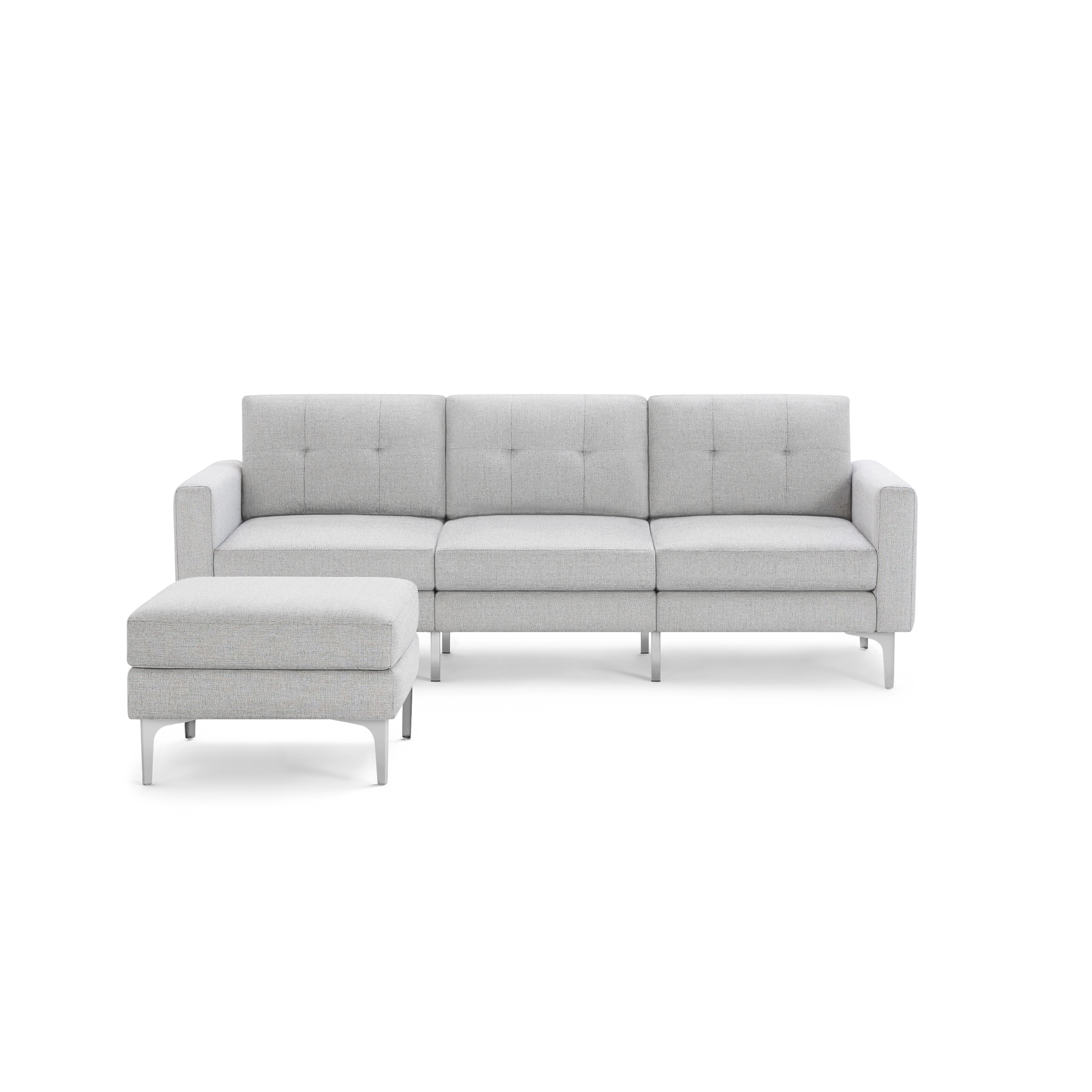 Light gray modern three-seat sofa with tufted back cushions and matching ottoman, supported by sleek metal legs.
