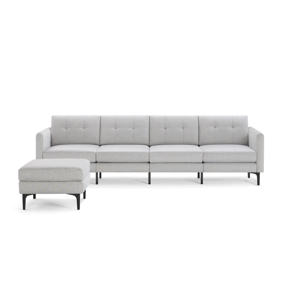 Light grey fabric sectional sofa with tufted back cushions, metal legs, and a matching ottoman on the left side.