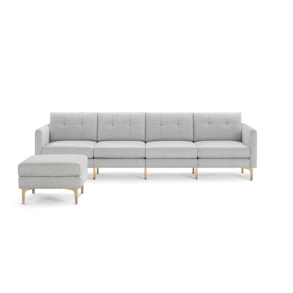 Light gray modern sectional sofa with tufted cushions, wooden legs, and a matching ottoman on the left side.