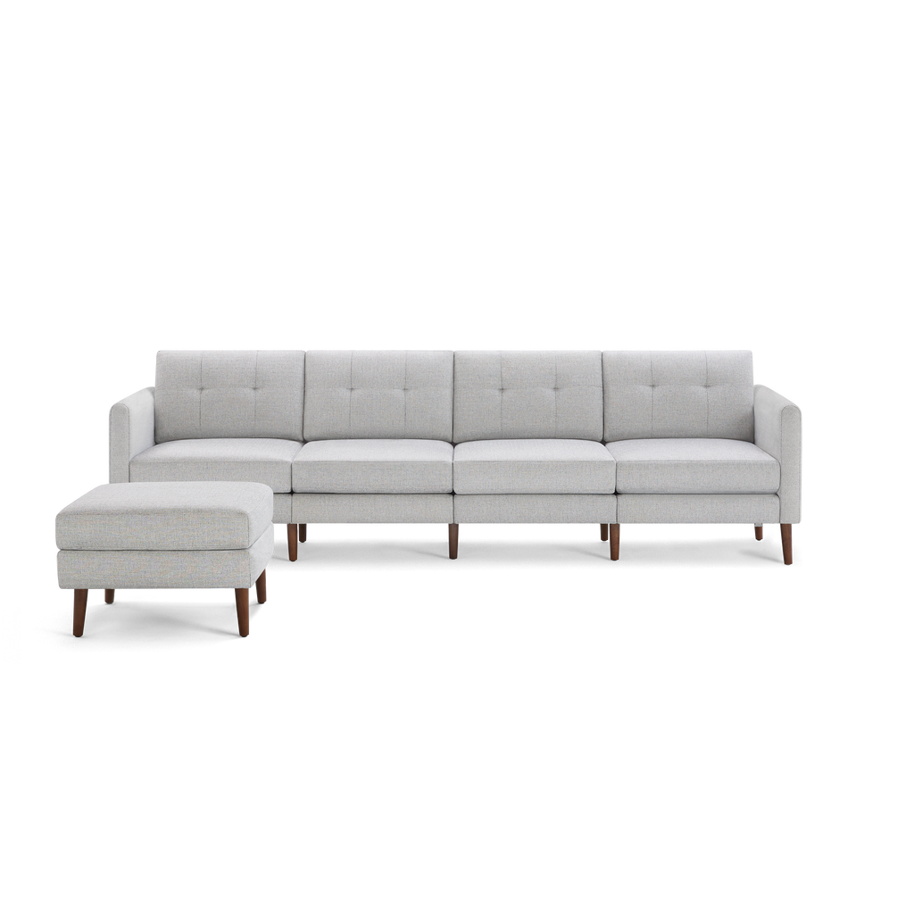 Light gray modern sectional sofa with tufted cushions, clean lines, and wooden tapered legs, accompanied by a matching ottoman.