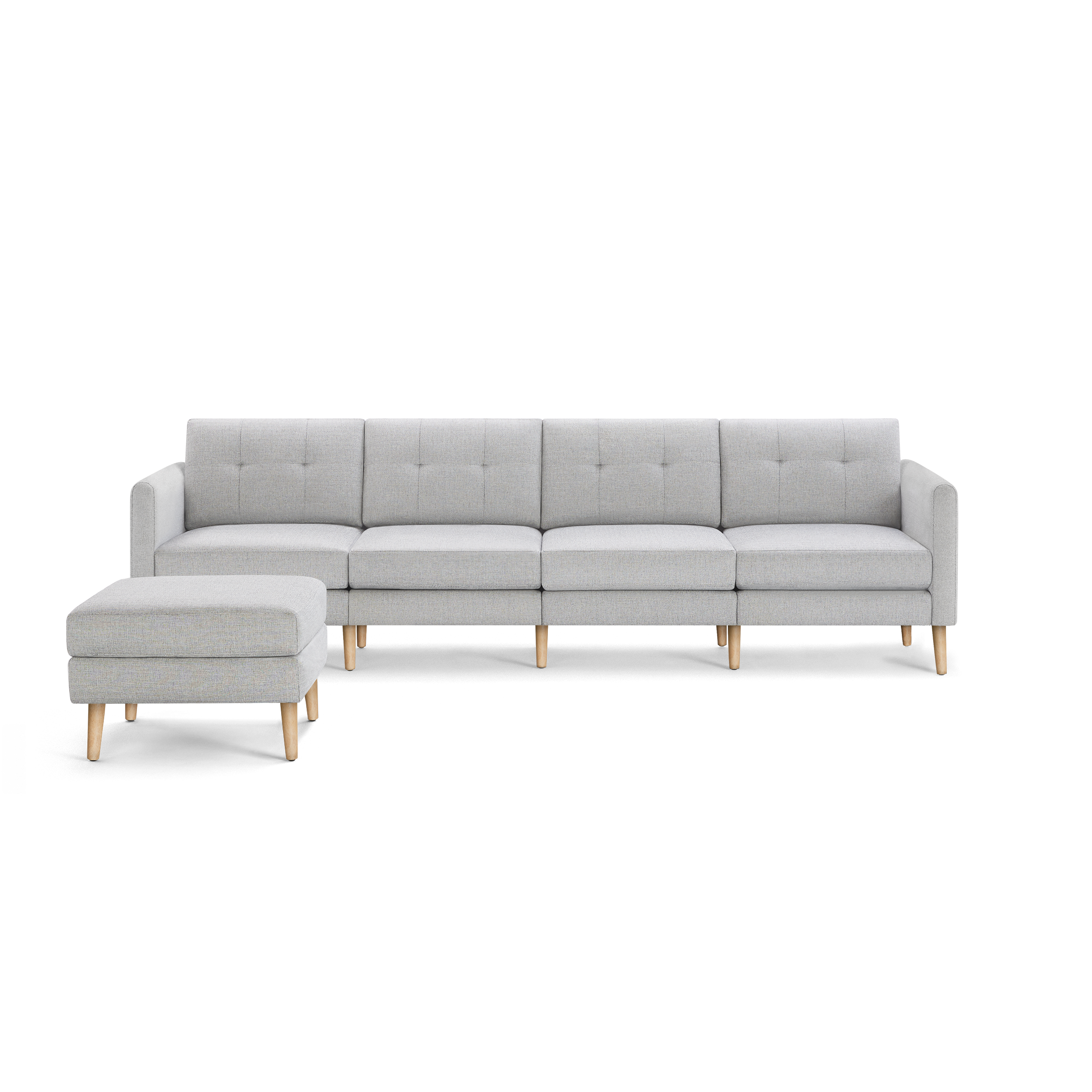 Light gray modern sectional sofa with tufted cushions, wooden legs, and a matching ottoman on the left side.
