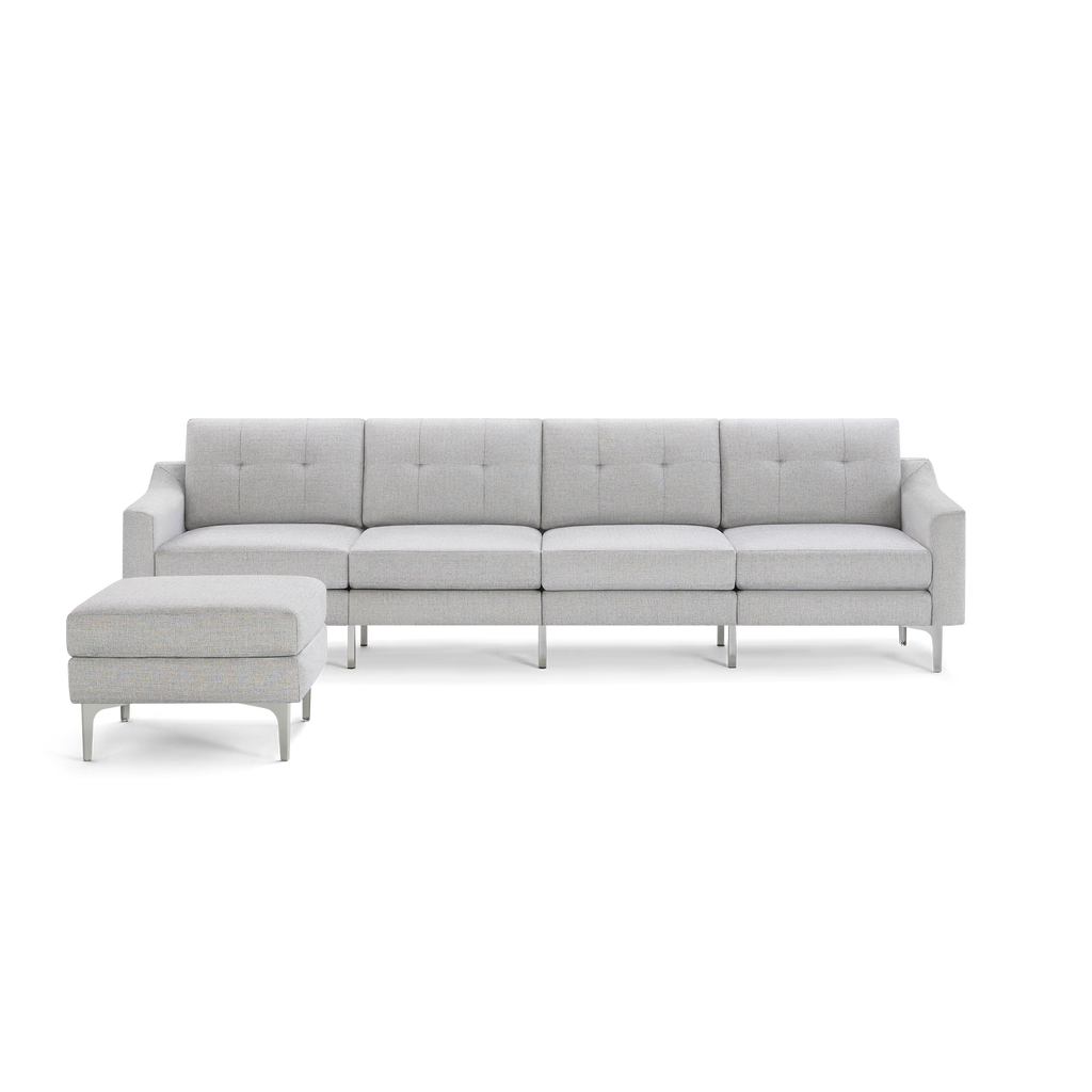 Light gray modern sectional sofa with tufted back cushions and matching ottoman, featuring sleek metal legs.