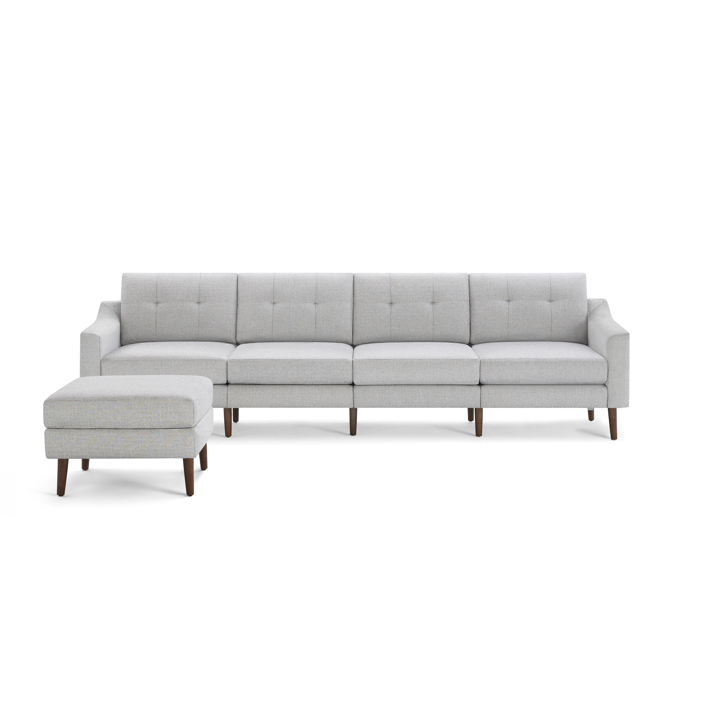 Light gray fabric sectional sofa with tufted cushions, wooden tapered legs, and matching ottoman on side.