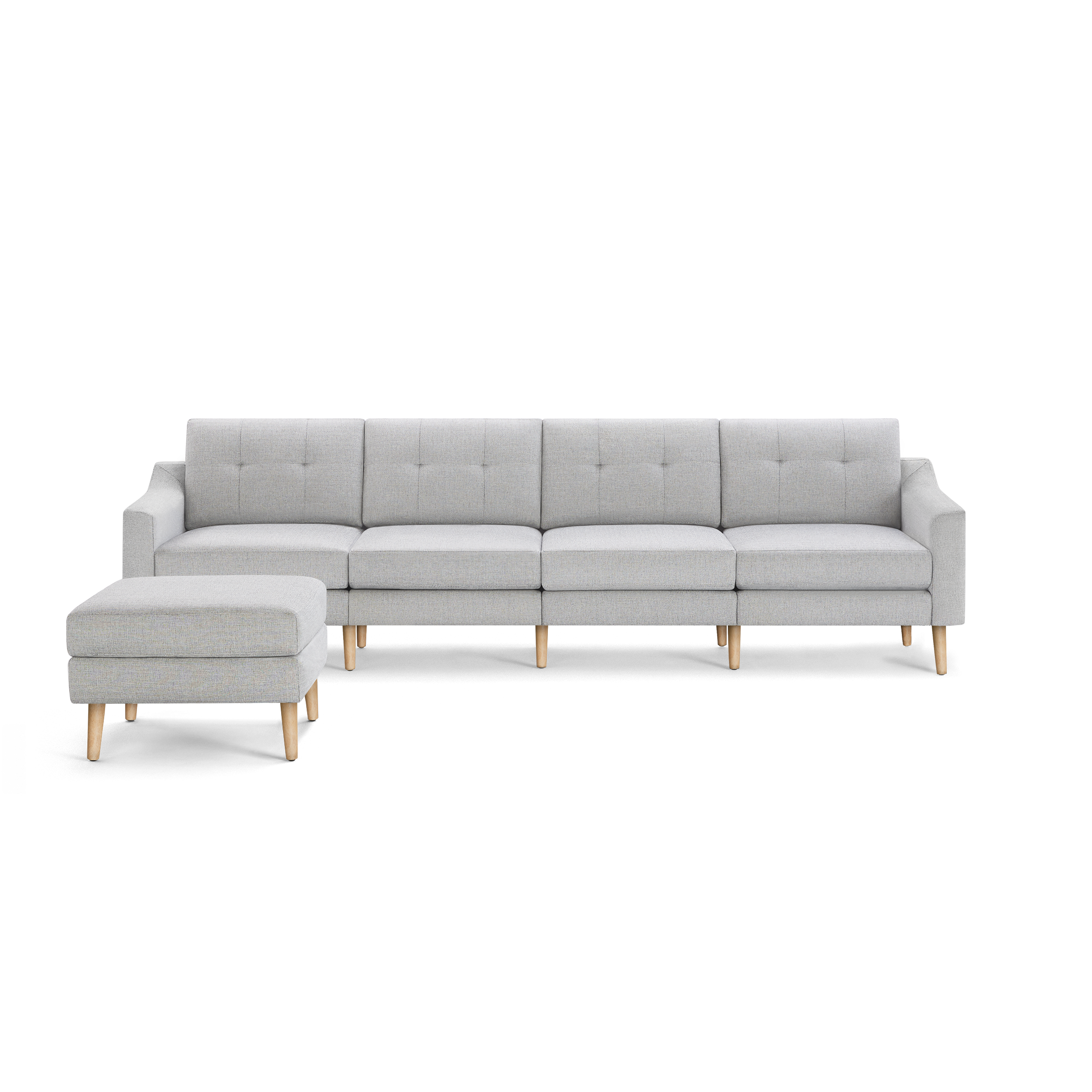 Light gray modern sectional sofa with tufted cushions, wooden legs, and a matching ottoman on the left side.