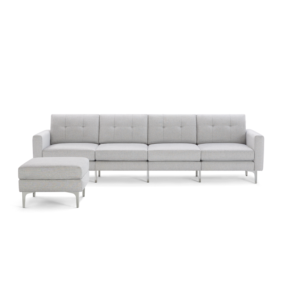 Light gray modern sectional sofa with tufted back cushions and matching ottoman, supported by sleek metal legs.