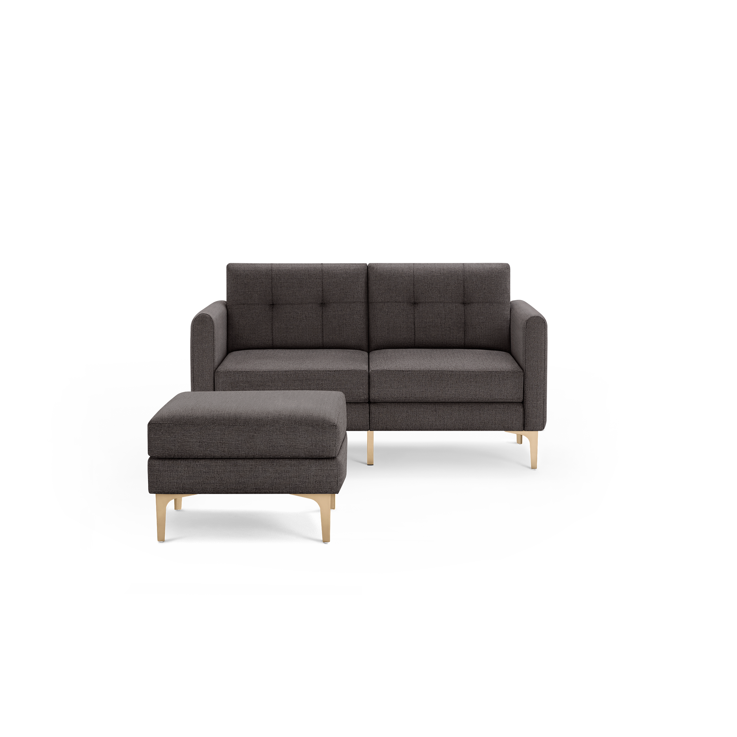 Modern dark gray two-seater sofa with matching ottoman, featuring tufted cushions and gold metal legs, isolated on black background.