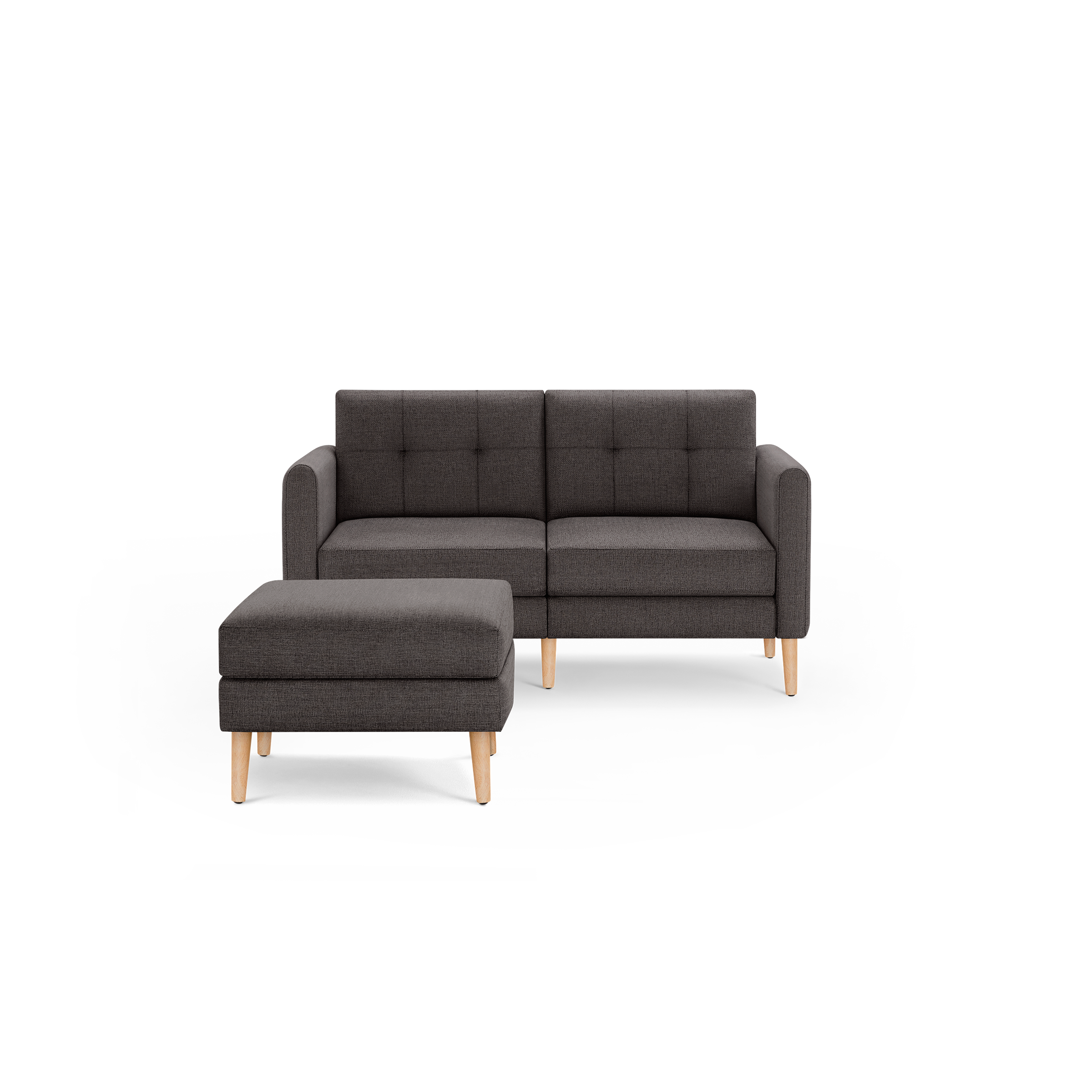 Dark gray two-seater sofa with tufted backrest and matching ottoman, both featuring light wooden legs.