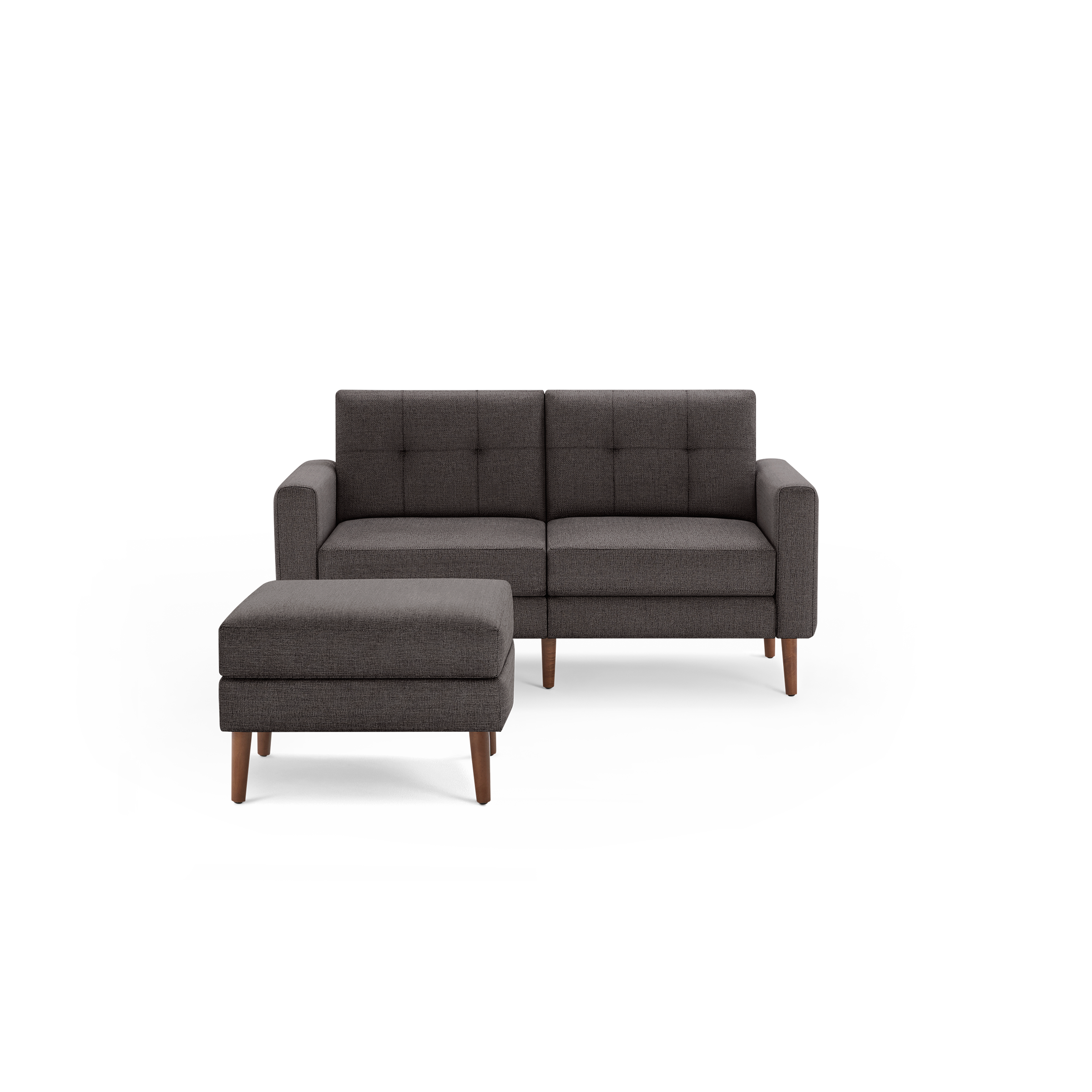 Dark gray tufted mid-century modern loveseat with matching cushioned ottoman and wooden legs on black background.