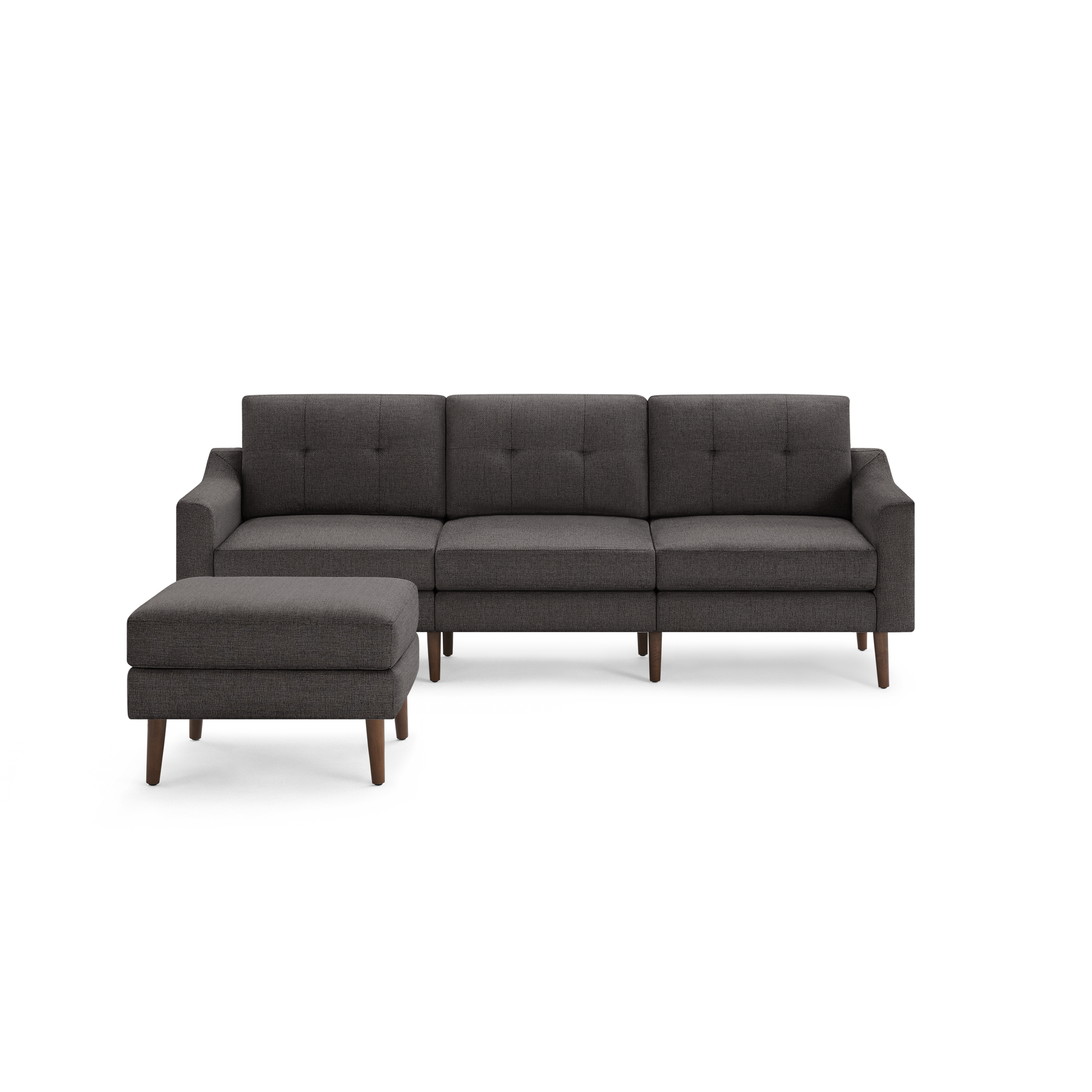 Dark gray fabric three-seater sofa with left-side matching ottoman, button-tufted back cushions, and wooden tapered legs.