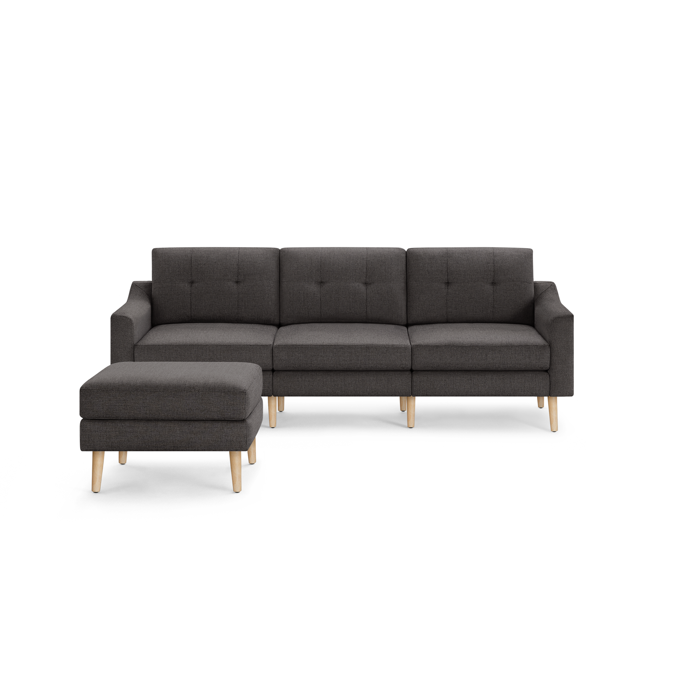 Modern dark gray fabric sectional sofa with tufted back cushions, wooden legs, and matching ottoman on the left side.