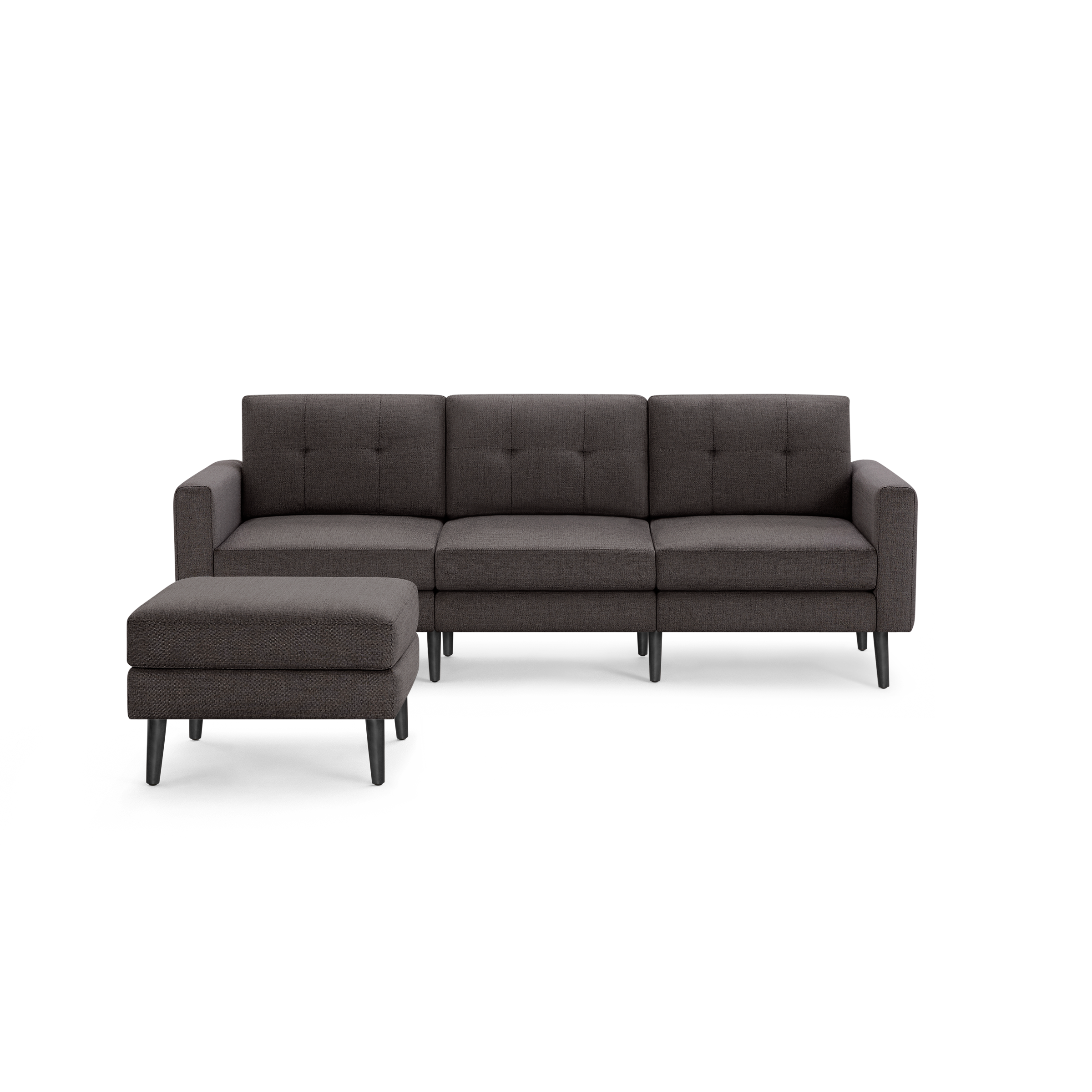Dark gray three-seater sofa with button-tufted back cushions and matching ottoman, featuring wooden tapered legs.