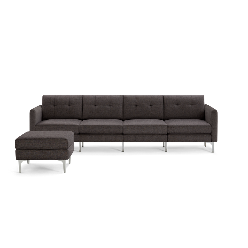 Dark gray modern sectional sofa with metal legs, tufted back cushions, and matching ottoman.