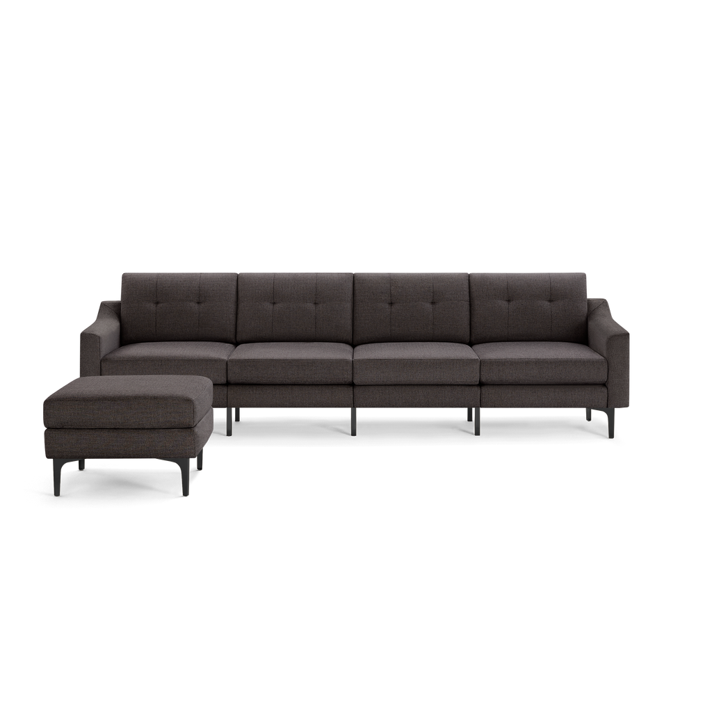 Modern dark gray upholstered sectional sofa with button-tufted back cushions and matching ottoman on black metal legs.