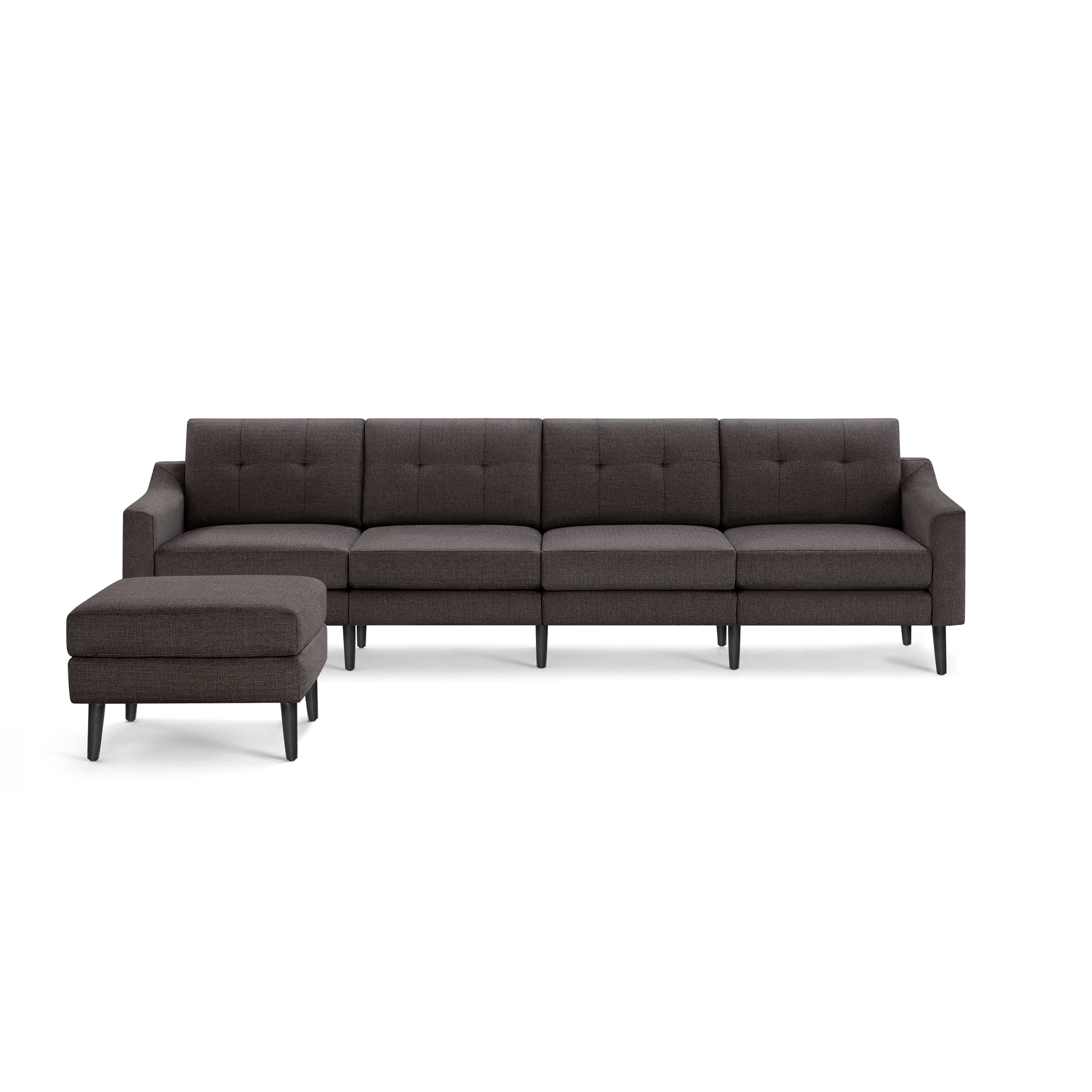 Dark gray fabric sectional sofa with tufted back cushions and matching ottoman on black tapered legs, modern design.