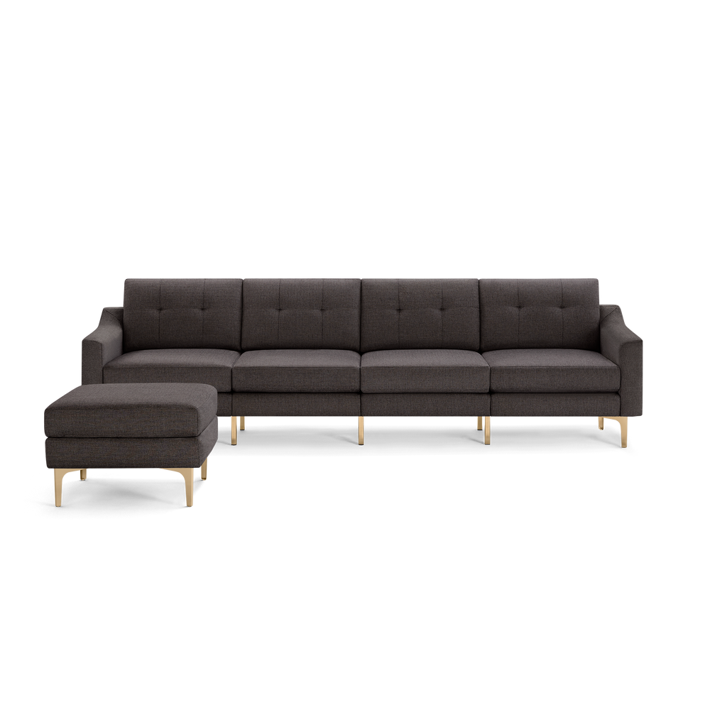 Dark gray fabric sectional sofa with tufted back cushions, wooden legs, and matching ottoman, modern and minimalist design.