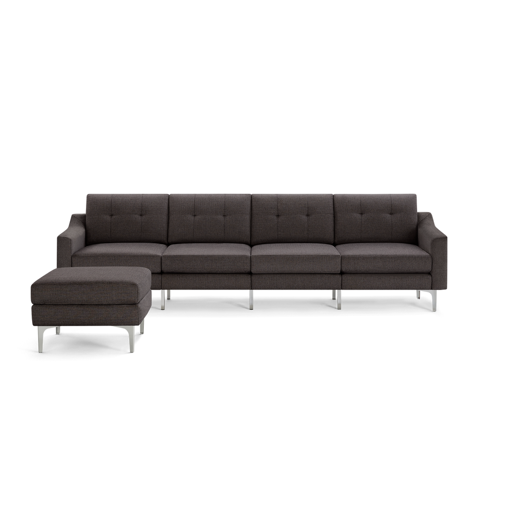 Modern dark gray fabric sectional sofa with tufted cushions, metal legs, and separate ottoman.