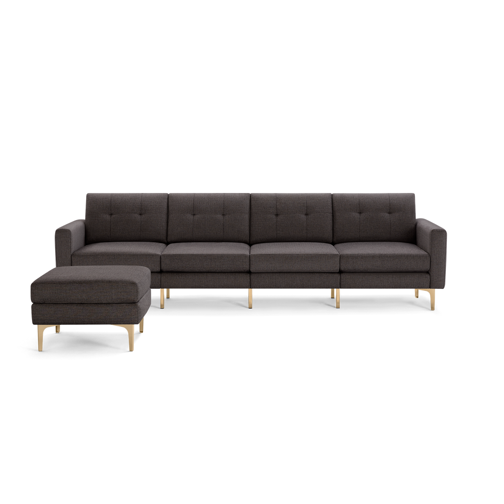 Dark gray modern sectional sofa with tufted cushions, clean lines, and light wooden legs, featuring a matching ottoman.