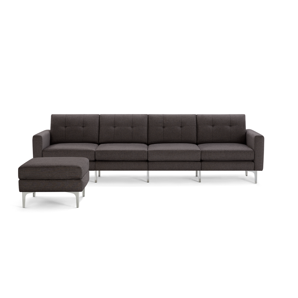 Modern dark gray fabric sectional sofa with metal legs and matching cushioned ottoman on a transparent background.