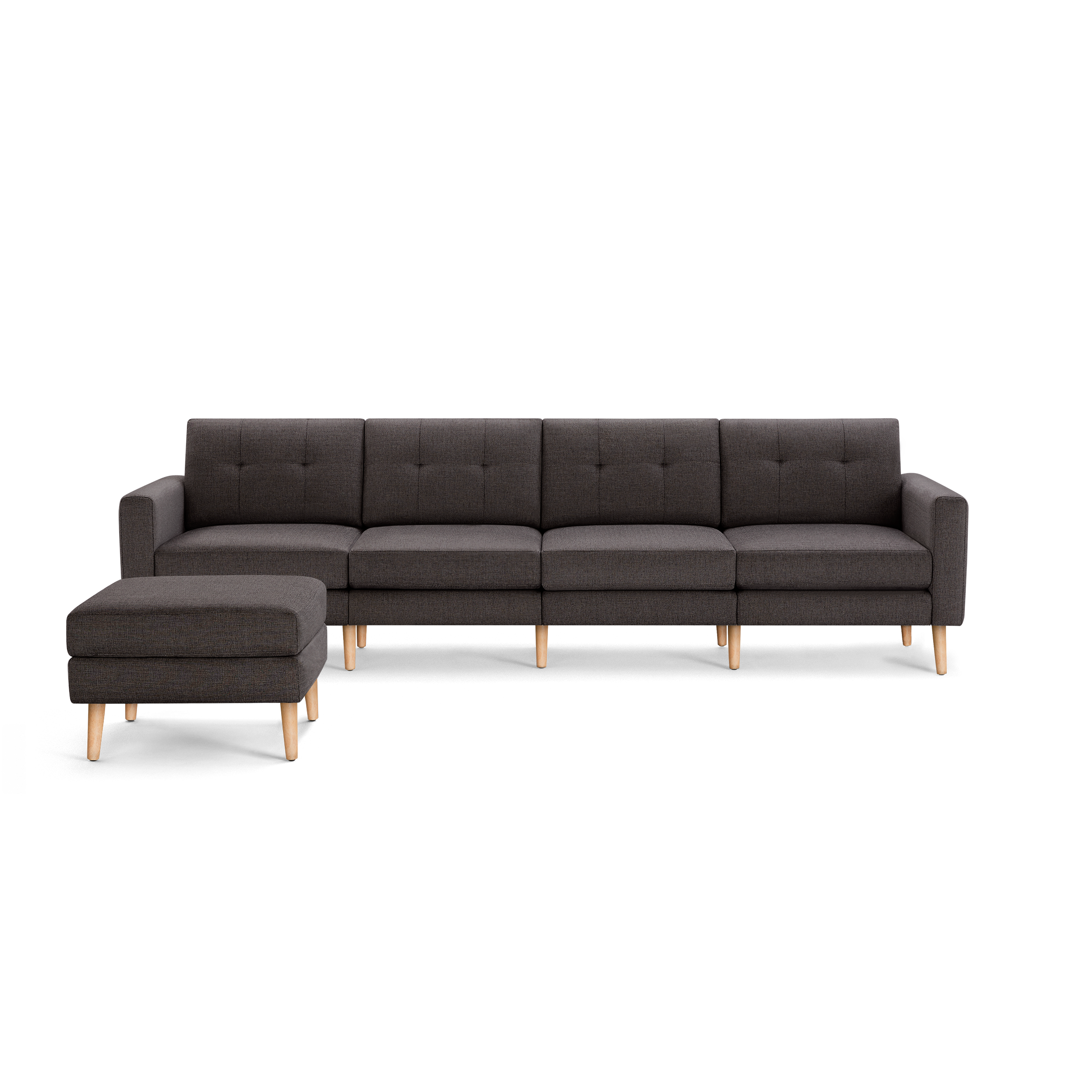 Dark gray modular sectional sofa with tufted back cushions and matching ottoman, supported by light wooden legs.