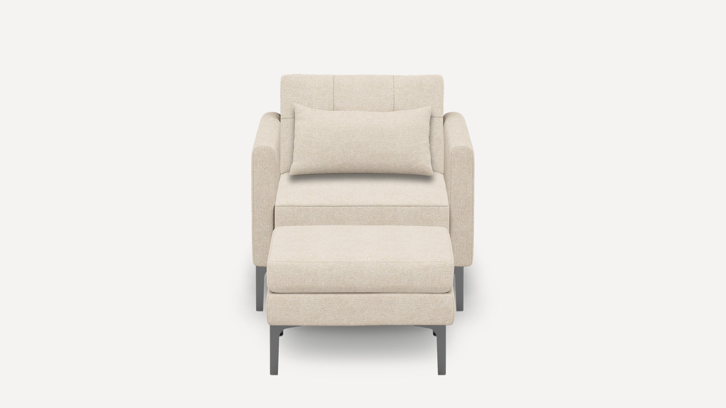 Beige upholstered armchair with matching rectangular pillow and ottoman, featuring slim dark metal legs, shown on white background.