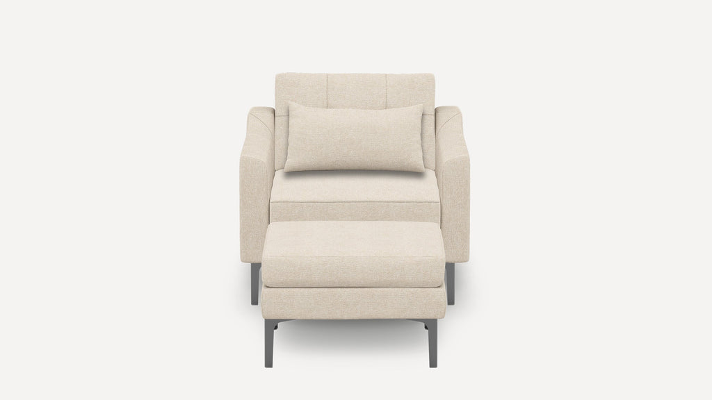 Beige modern armchair with matching ottoman, featuring clean lines, soft fabric upholstery, and slim metal legs.