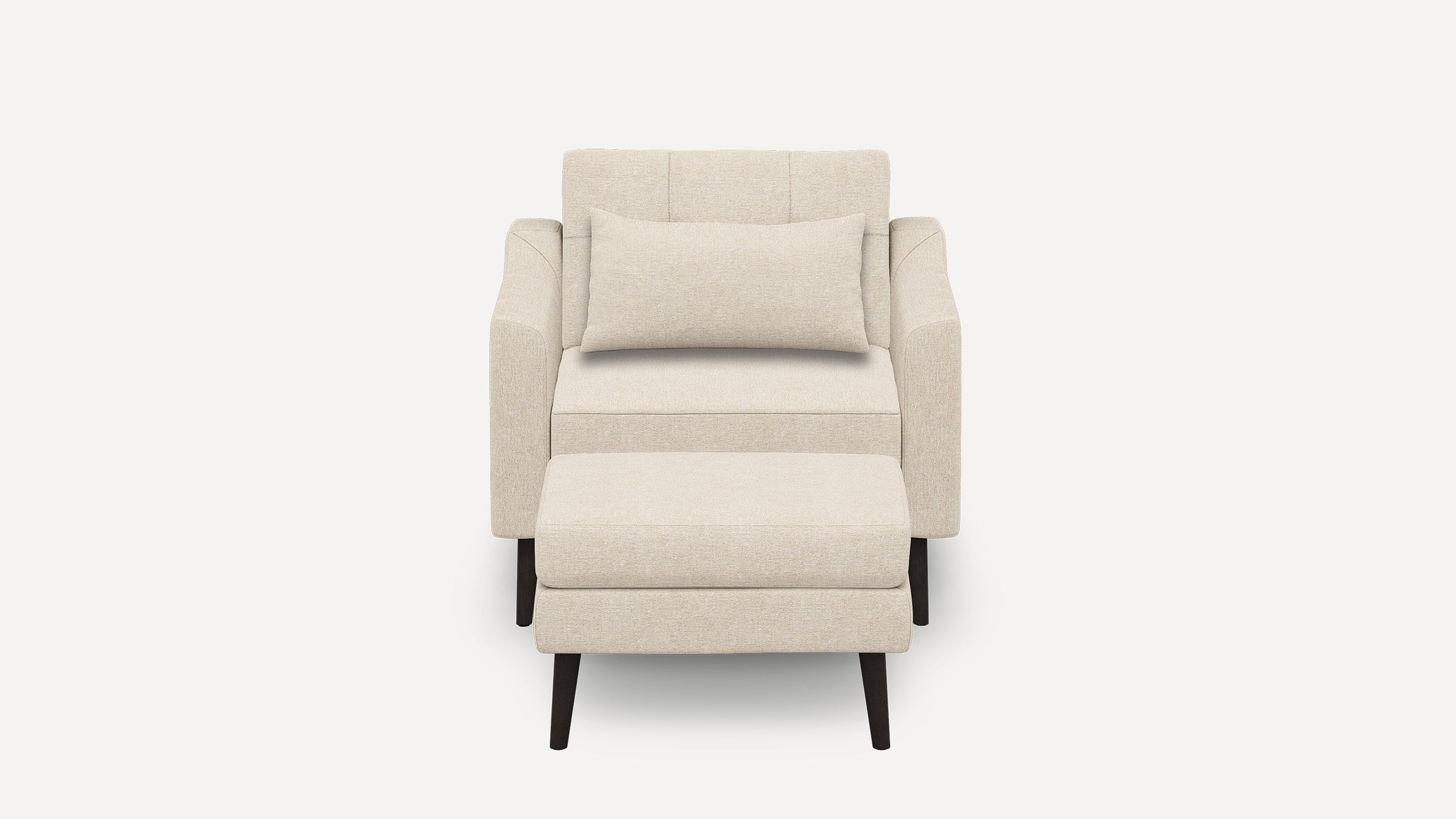 Beige upholstered armchair with matching rectangular lumbar pillow and separate cushioned ottoman, supported by dark wooden legs.