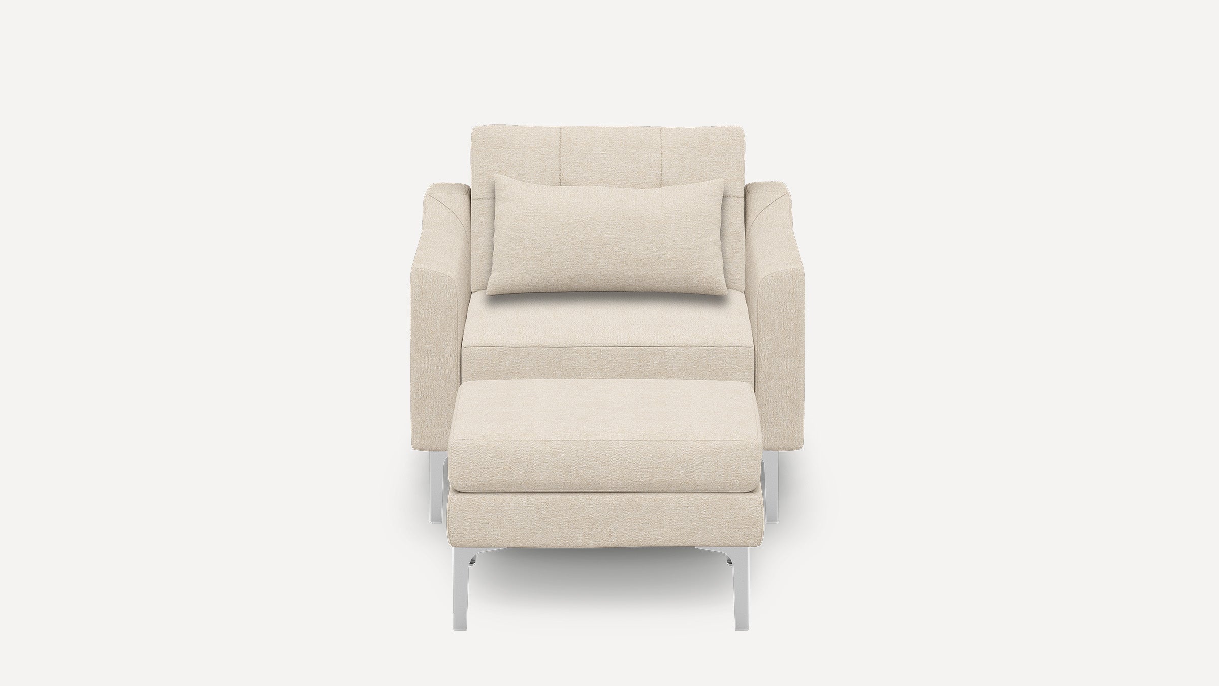 Front view of a modern beige fabric armchair with matching cushioned ottoman and rectangular lumbar pillow, supported by silver metal legs.