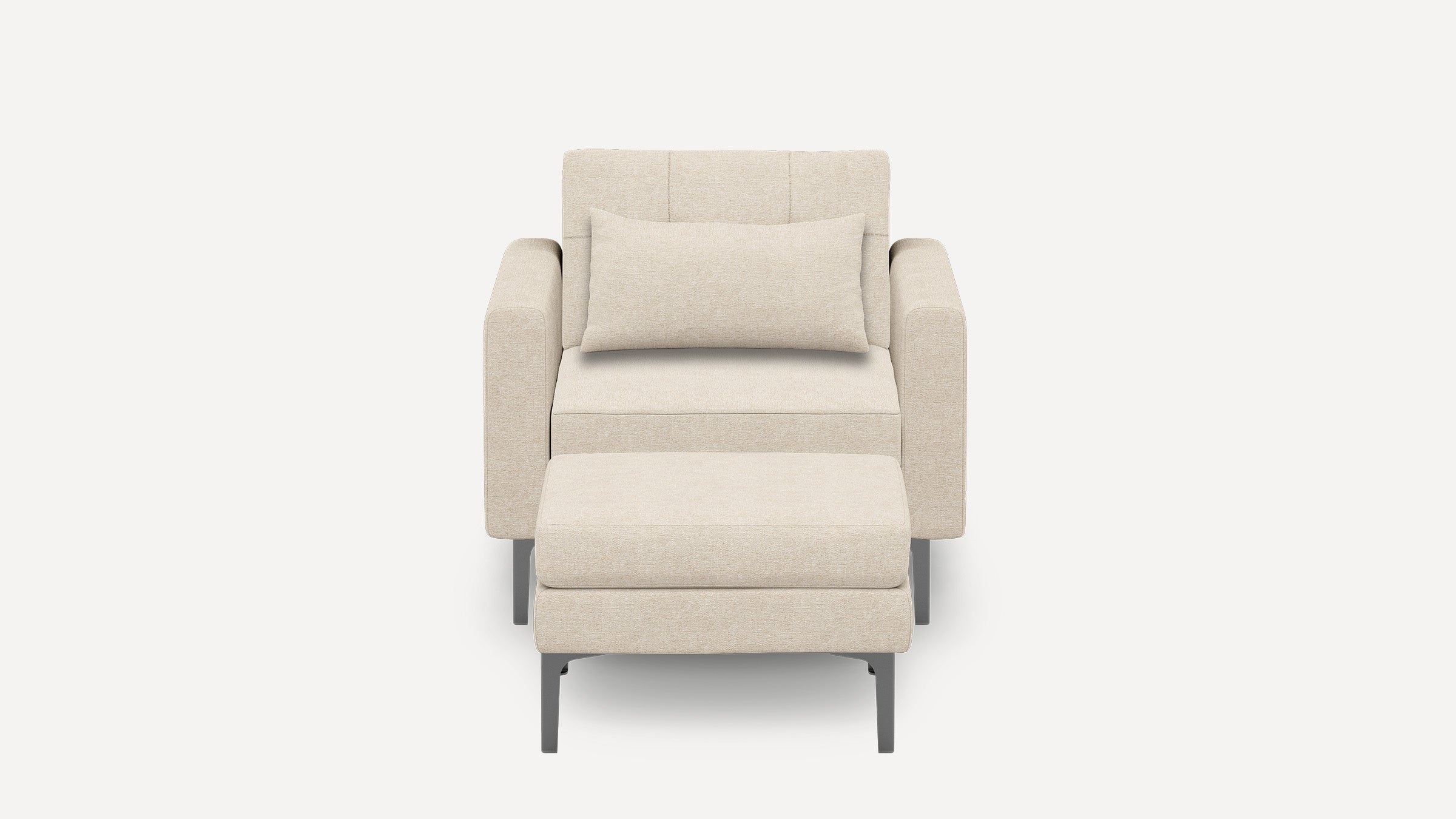 Modern beige armchair with matching rectangular cushion and ottoman, featuring sleek metal legs and soft fabric upholstery.