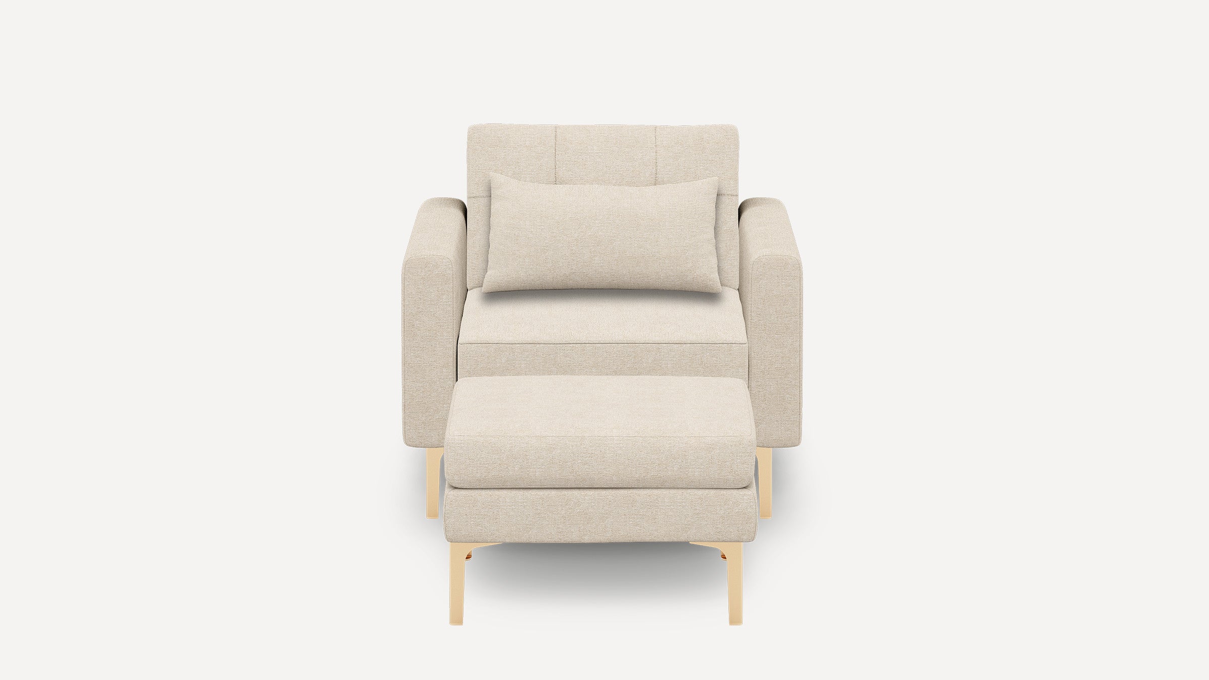 Beige upholstered armchair with matching rectangular lumbar pillow and ottoman, supported by light wooden legs, shown against a plain white background.