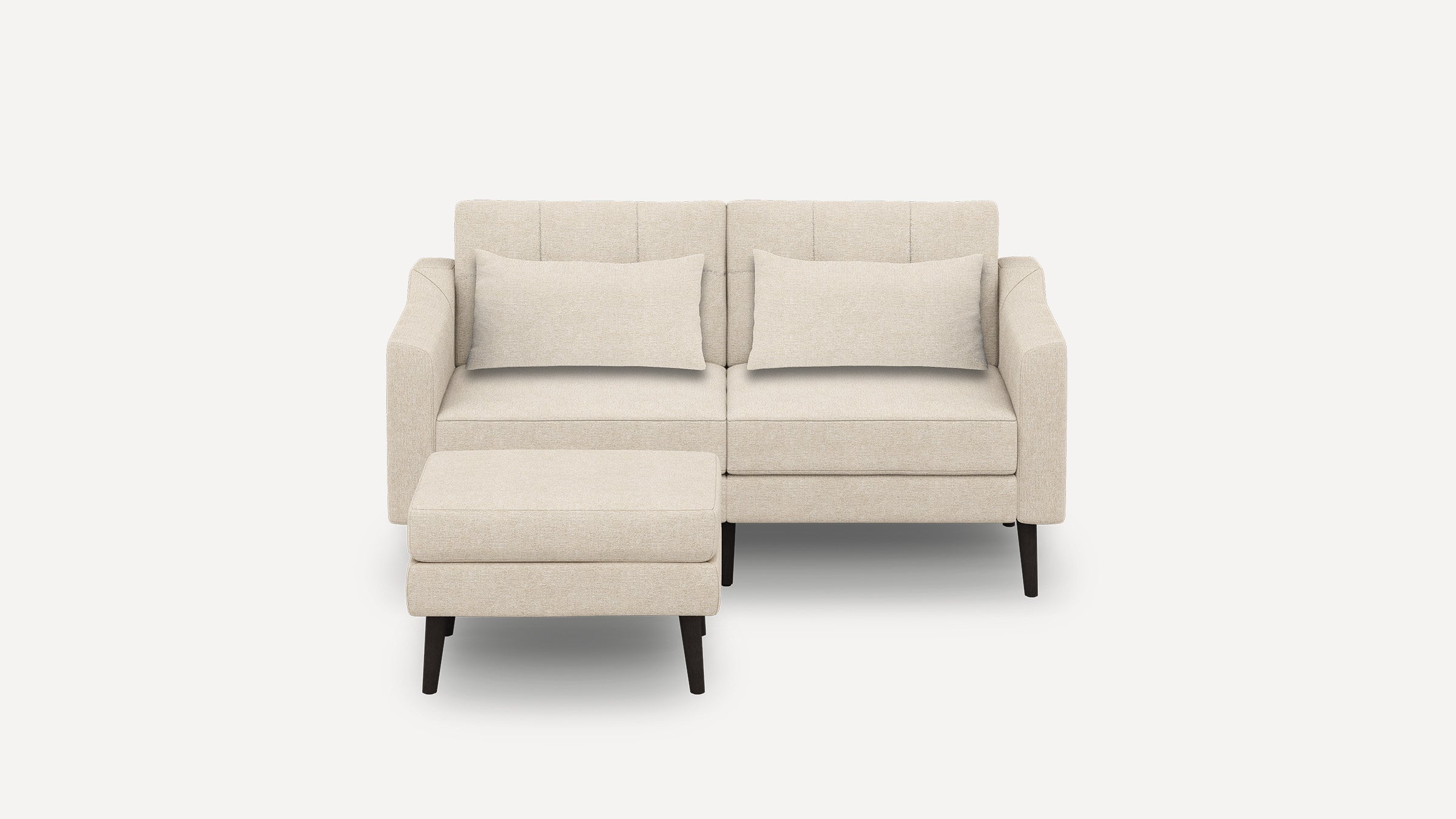 Beige upholstered modern loveseat sofa with two matching cushions and a separate ottoman, supported by dark wooden legs.