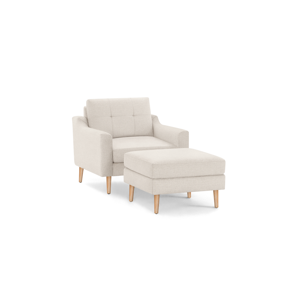 Beige fabric armchair with matching cushioned ottoman, featuring wooden legs and a tufted backrest for modern comfort.