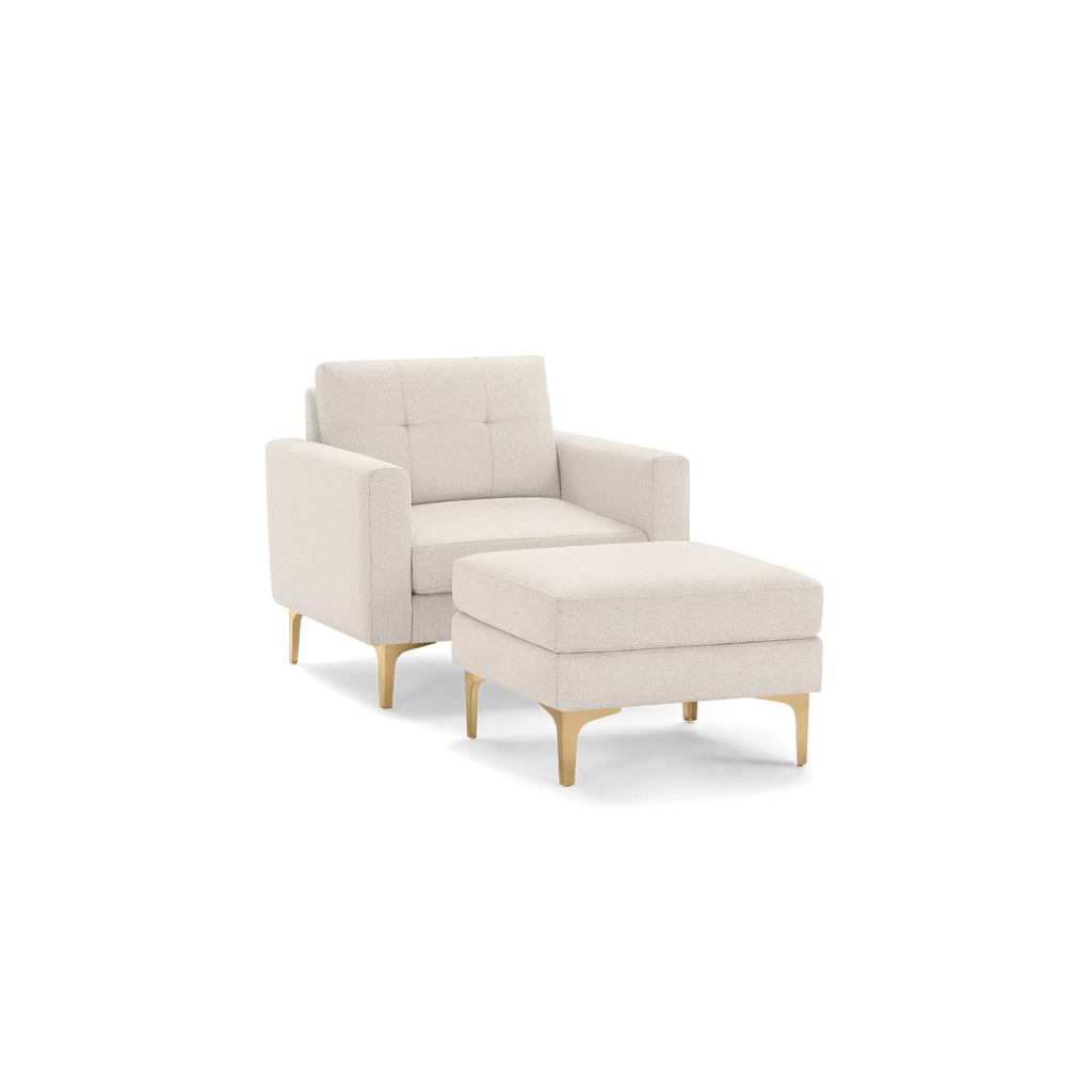 Beige modern armchair with matching ottoman, featuring gold-colored legs and tufted backrest for stylish comfort.