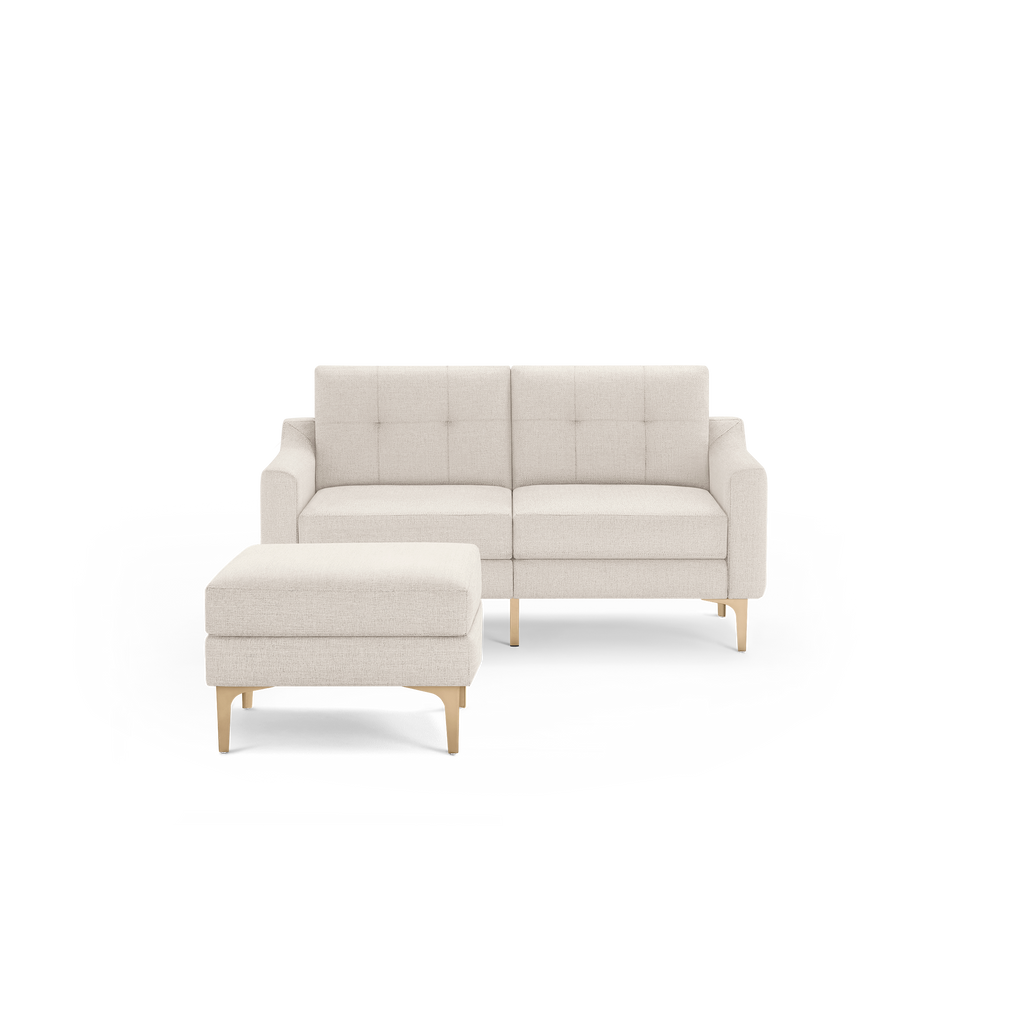 Two-piece beige fabric loveseat sofa with matching ottoman, tufted back cushions, and light wooden legs.