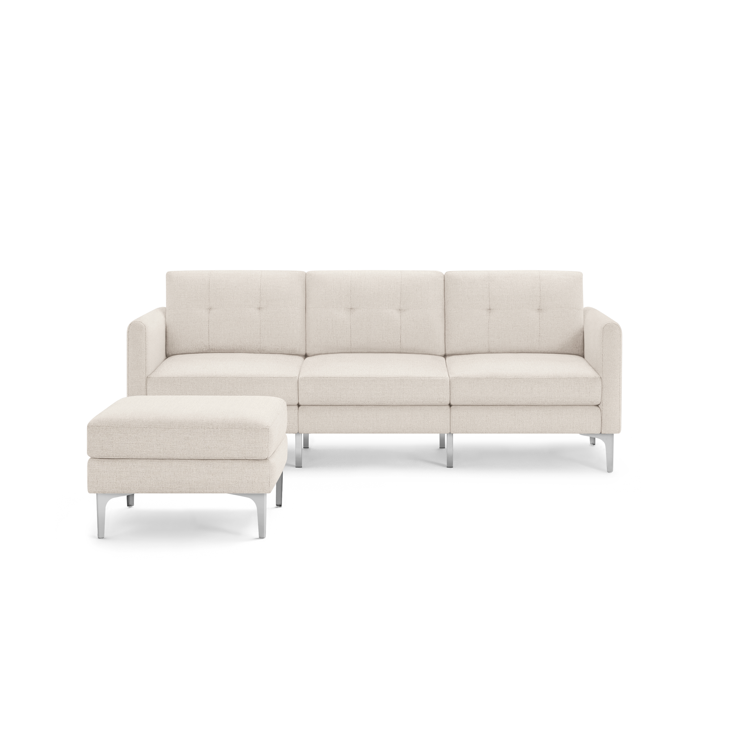 Beige three-seater sectional sofa with tufted cushions, metal legs, and matching ottoman on left side, isolated on black background.
