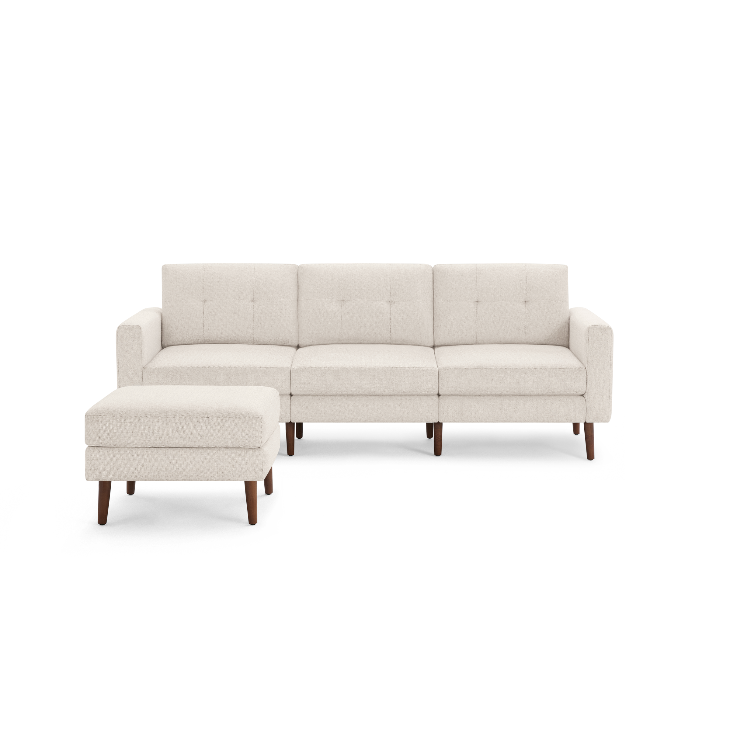 Beige three-seater sofa with tufted back cushions and matching ottoman, both featuring wooden legs.