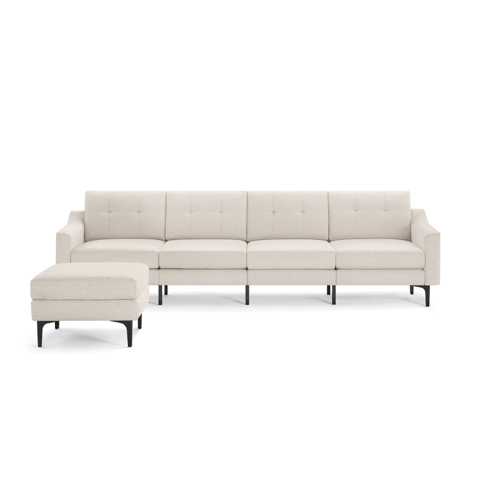 Beige L-shaped sectional sofa with tufted back cushions and black metal legs, including a matching ottoman.