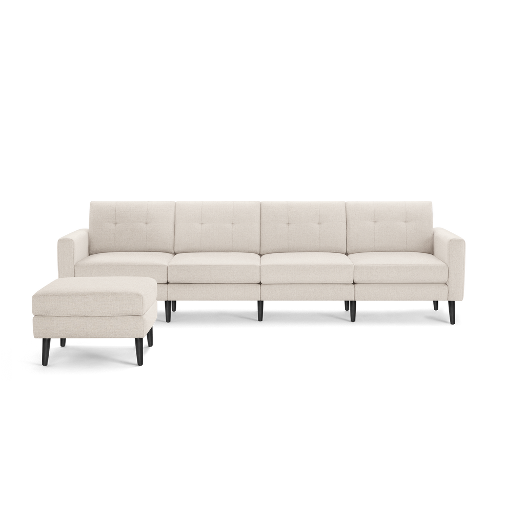 Beige fabric sectional sofa with tufted cushions and matching ottoman, featuring black wooden legs and clean modern design.