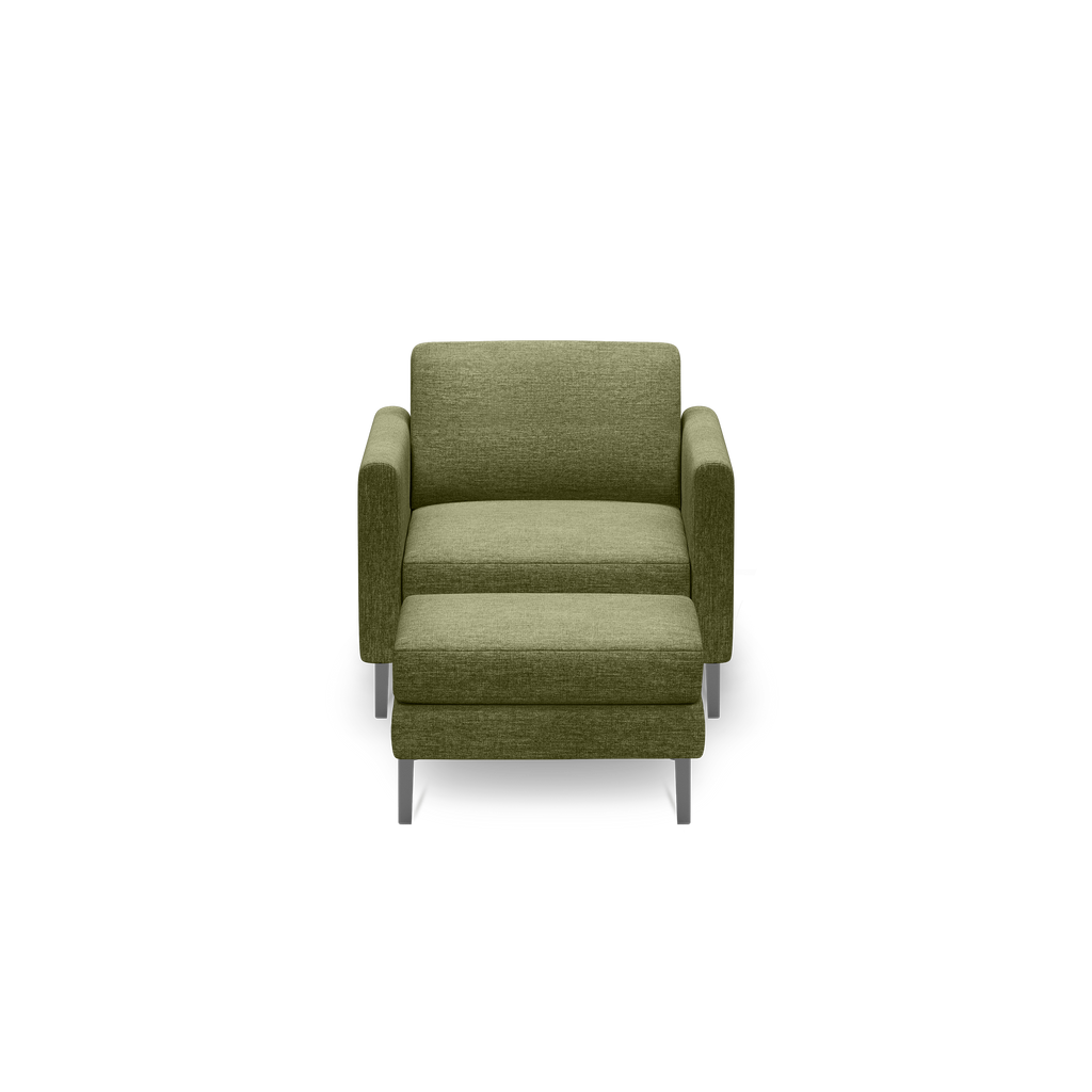 Front view of a modern olive green upholstered armchair with metal legs and a matching ottoman, isolated on black background.