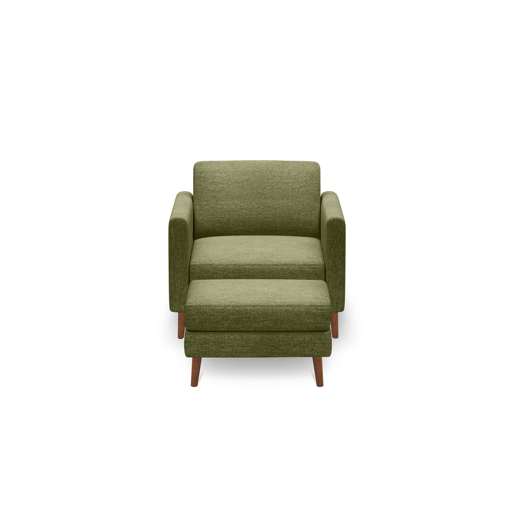 Front view of a modern olive green upholstered armchair with wooden legs on a black background.