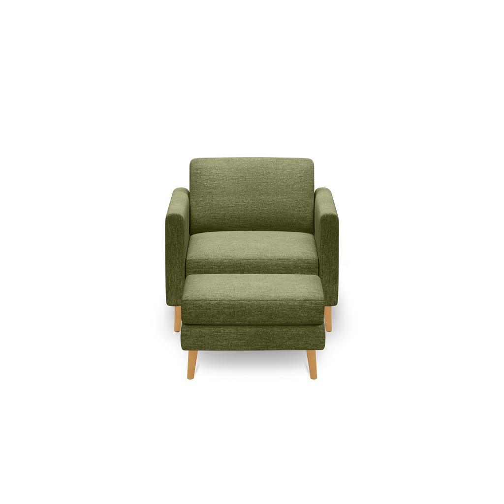 Front view of a modern olive green fabric armchair with wooden legs and a matching ottoman on a black background.