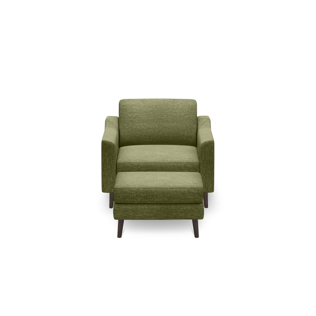Green fabric armchair with a matching ottoman, featuring wooden legs and a modern, minimalist design.