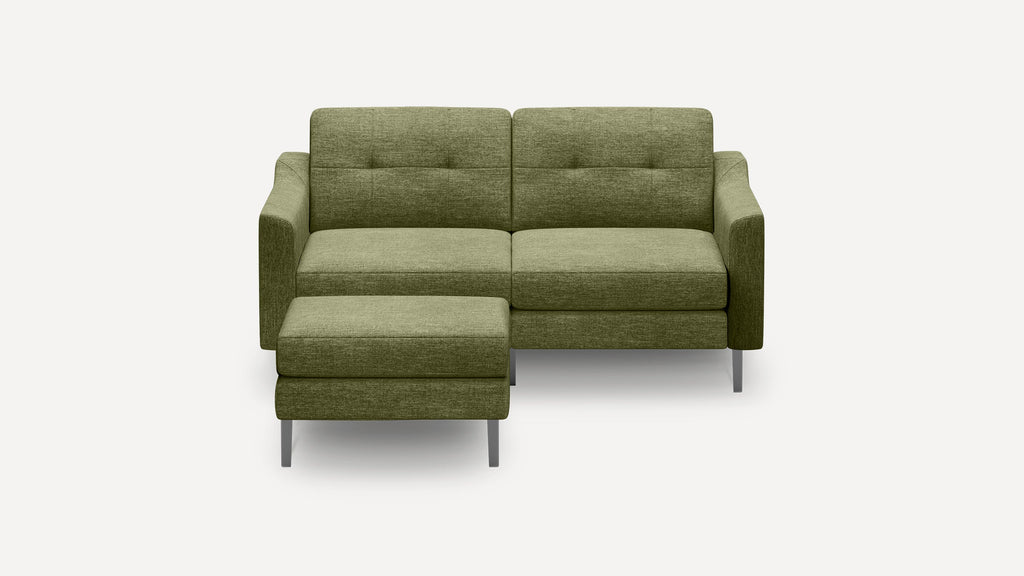 Modern green fabric sectional sofa with clean lines, cushioned seats, metal legs, and an attached chaise lounge on left side.